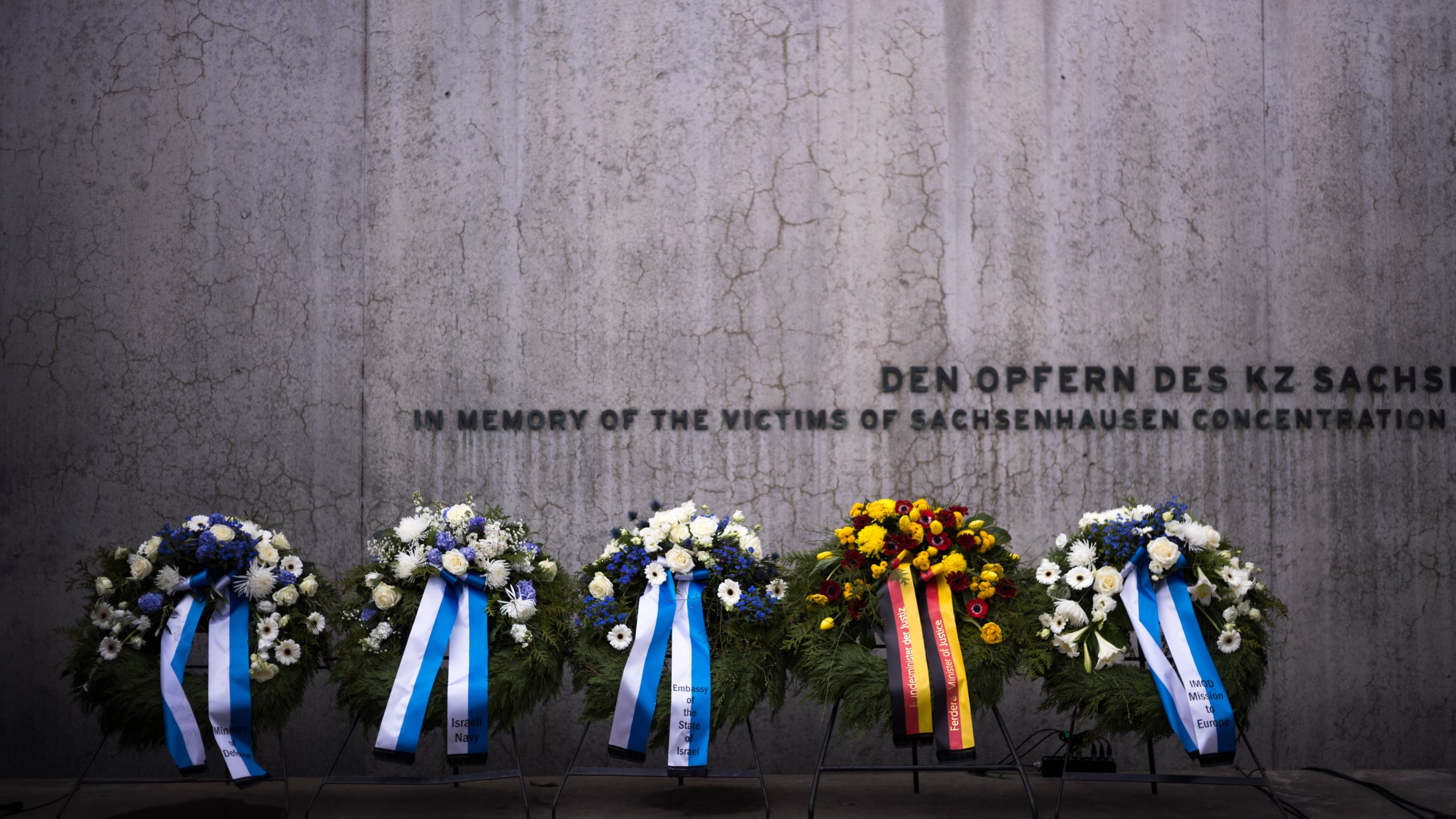 FILE - Wreaths at the memorial wall of the Nazi concentration camp Sachsenhausen after a ceremony marking the Holocaust Martyrs' and Heroes' Remembrance Day in Oranienburg, Germany, Tuesday, April 18, 2023. German prosecutors say a 98-year-old man has been charged with being an accessory to murder as a guard at the Nazis’ Sachsenhausen concentration camp between 1943 and 1945. Nazis’ Sachsenhausen concentration camp between 1943 and 1945. (AP Photo/Markus Schreiber, File)