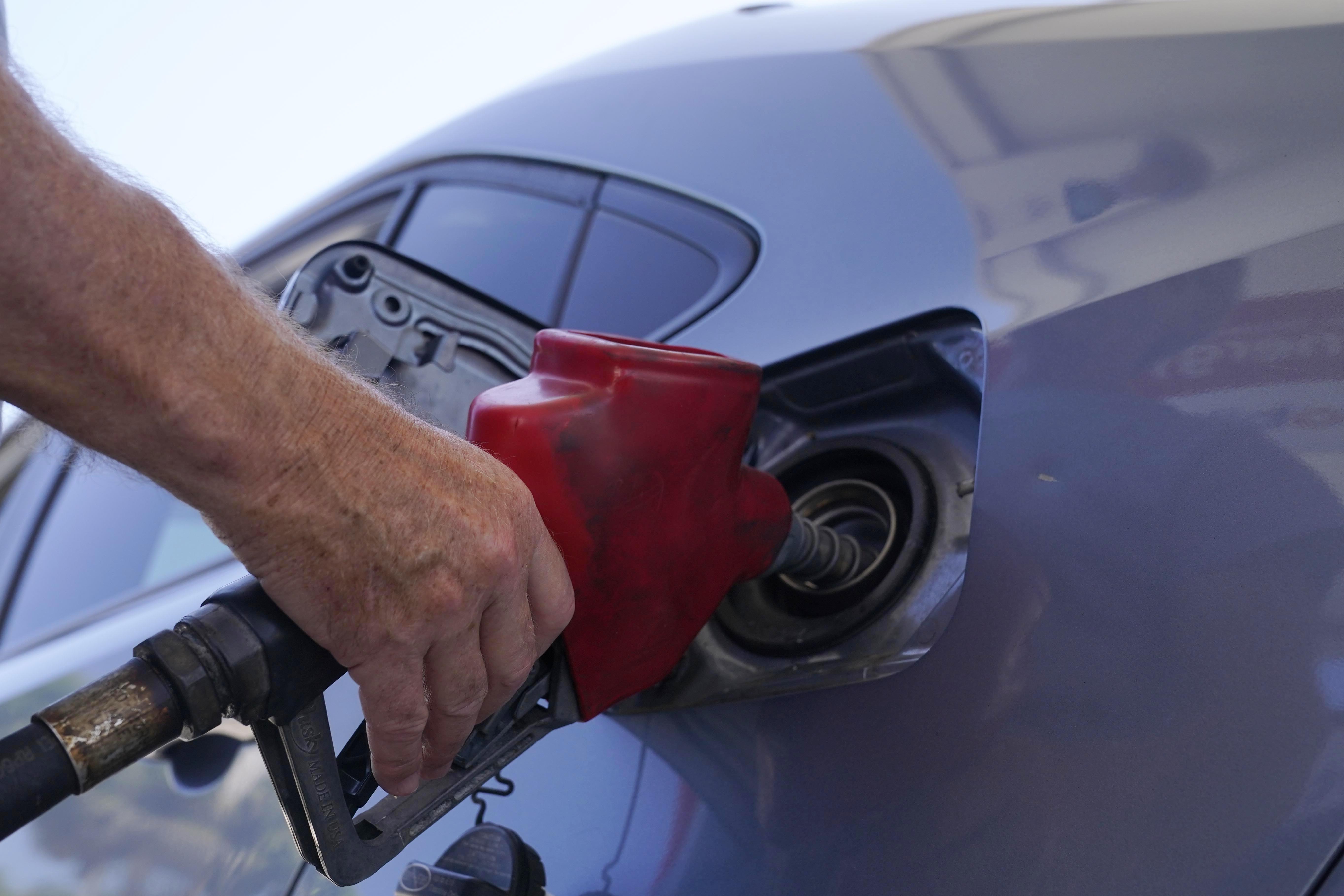 FILE - A customer pumps gas at an Exxon gas station, Tuesday, May 10, 2022, in Miami. Saudi Arabia and Russia agreed Tuesday, Sept. 5, 2023, to extend their voluntary oil production cuts through the end of this year, trimming 1.3 million barrels of crude out of the global market and boosting energy prices. The dual announcements from Riyadh and Moscow pushed benchmark Brent crude above $90 a barrel in trading Tuesday afternoon, a price unseen in the market since last November. (AP Photo/Marta Lavandier, File)