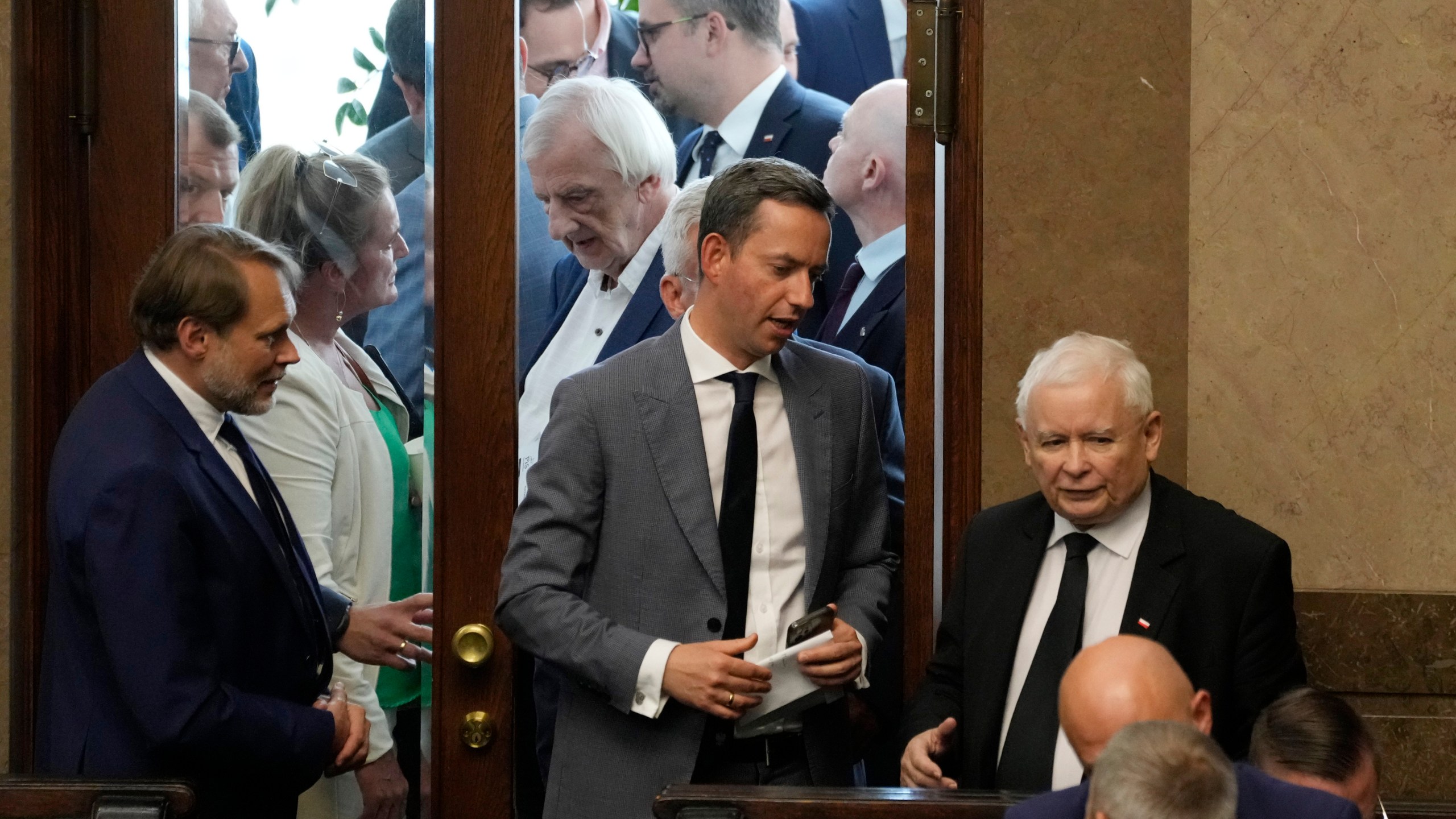 The leader of Poland's ruling party Jaroslaw Kaczynski ,right, during parliament vote to confirm that a government-planned controversial referendum on migration will be held alongside key parliamentary elections on Oct. 15, at the lower house of parliament in Warsaw, Poland, on Thursday, Aug. 2023. Critics say the referendum is a campaign ploy by ruling Law and Justice party to discredit the opposition and rally voters around government politics. (AP Photo/Czarek Sokolowski)