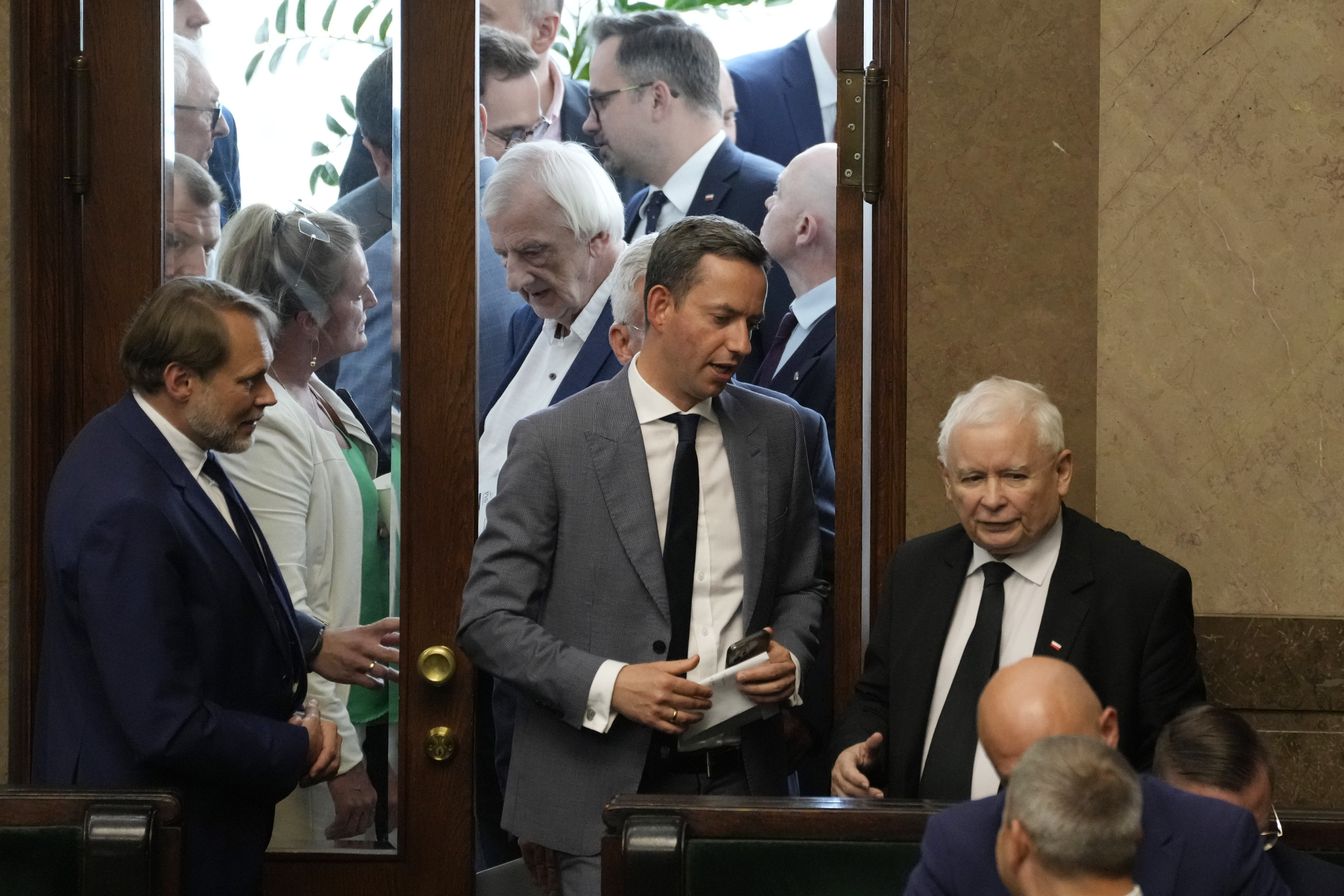 The leader of Poland's ruling party Jaroslaw Kaczynski ,right, during parliament vote to confirm that a government-planned controversial referendum on migration will be held alongside key parliamentary elections on Oct. 15, at the lower house of parliament in Warsaw, Poland, on Thursday, Aug. 2023. Critics say the referendum is a campaign ploy by ruling Law and Justice party to discredit the opposition and rally voters around government politics. (AP Photo/Czarek Sokolowski)