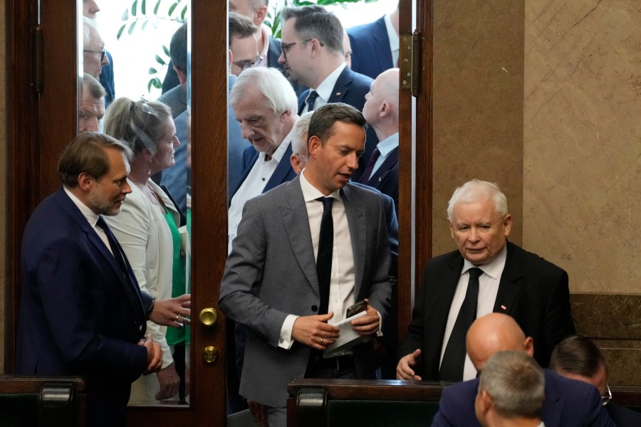 The leader of Poland's ruling party Jaroslaw Kaczynski ,right, during parliament vote to confirm that a government-planned controversial referendum on migration will be held alongside key parliamentary elections on Oct. 15, at the lower house of parliament in Warsaw, Poland, on Thursday, Aug. 2023. Critics say the referendum is a campaign ploy by ruling Law and Justice party to discredit the opposition and rally voters around government politics. (AP Photo/Czarek Sokolowski)