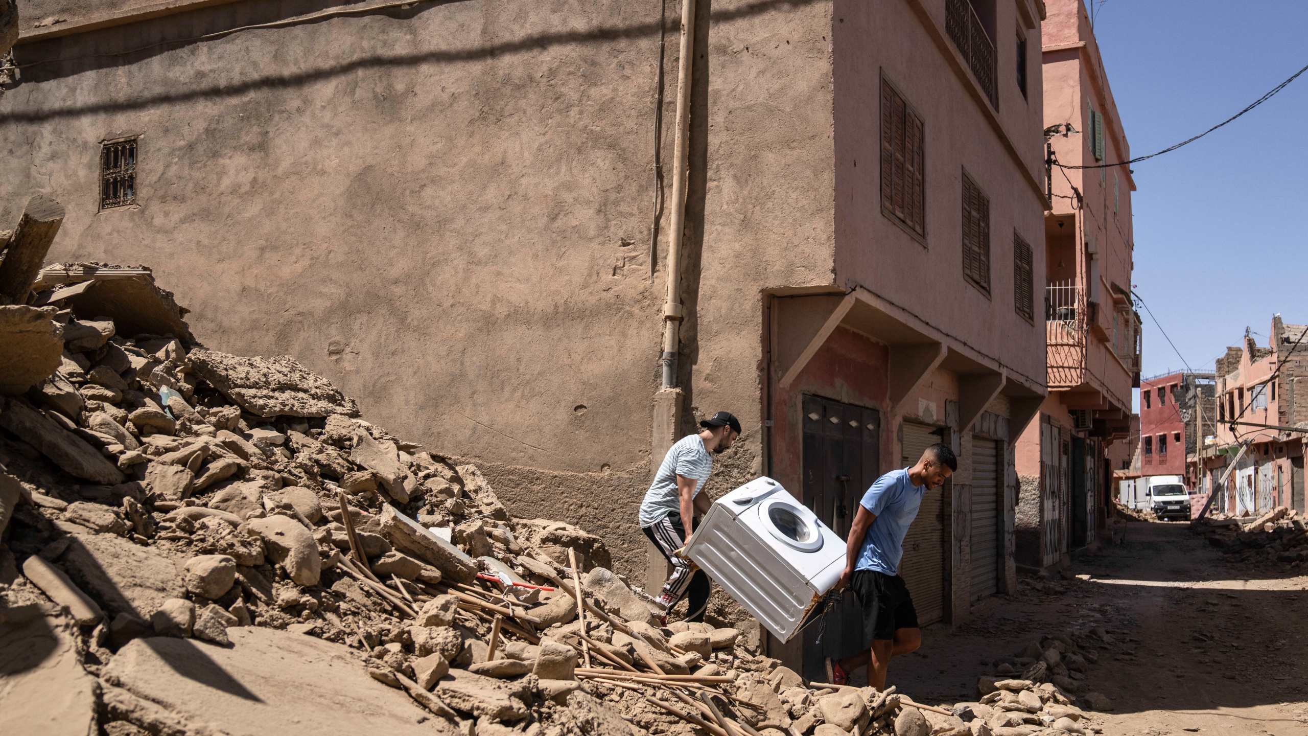 People recover a washing machine from their home that was damaged by the earthquake, in the town of Amizmiz, near Marrakech, Morocco, Sunday, Sept. 10, 2023. An aftershock rattled Moroccans on Sunday as they prayed for victims of the nation’s strongest earthquake in more than a century and toiled to rescue survivors while soldiers and workers brought water and supplies to desperate mountain villages in ruins. (AP Photo/Mosa'ab Elshamy)