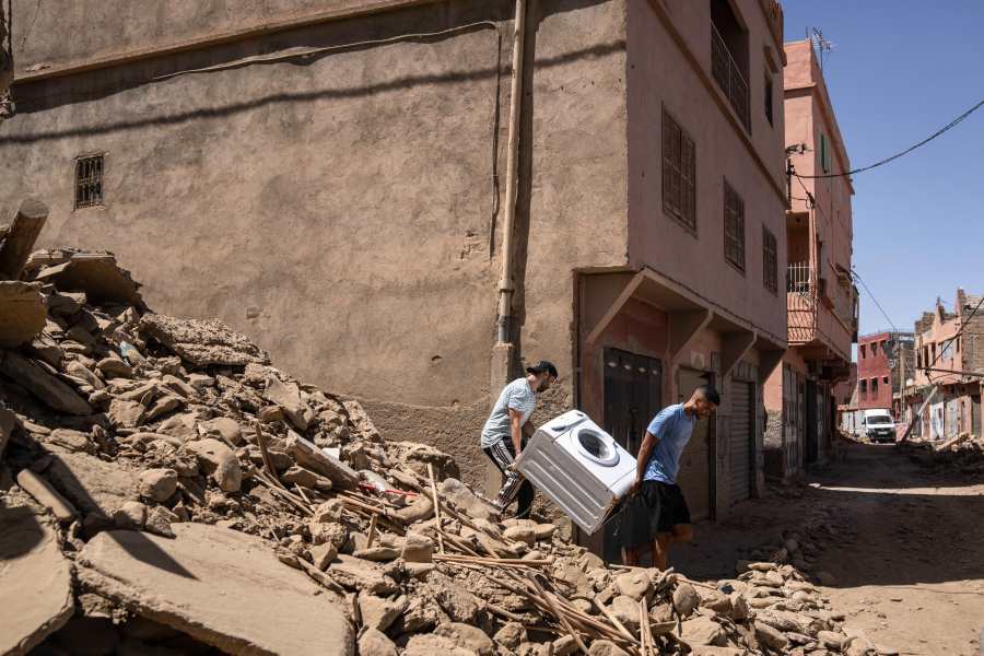 People recover a washing machine from their home that was damaged by the earthquake, in the town of Amizmiz, near Marrakech, Morocco, Sunday, Sept. 10, 2023. An aftershock rattled Moroccans on Sunday as they prayed for victims of the nation’s strongest earthquake in more than a century and toiled to rescue survivors while soldiers and workers brought water and supplies to desperate mountain villages in ruins. (AP Photo/Mosa'ab Elshamy)