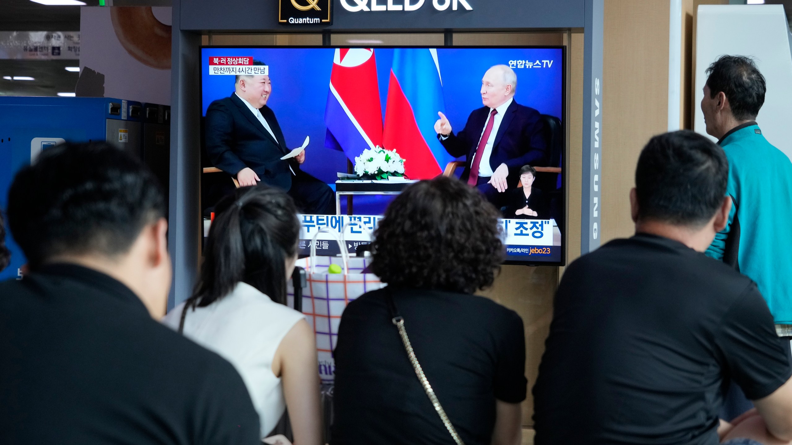 A TV screen shows an image of a meeting between Russian President Vladimir Putin, right, and North Korea's leader Kim Jong Un during a news program at the Seoul Railway Station in Seoul, South Korea, Thursday, Sept. 14, 2023. Kim vowed "full and unconditional support" for Putin on Wednesday as the two leaders isolated by the West held a summit that the U.S. warned could lead to a deal to supply ammunition for Moscow's war in Ukraine. (AP Photo/Ahn Young-joon)