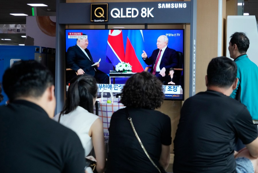 A TV screen shows an image of a meeting between Russian President Vladimir Putin, right, and North Korea's leader Kim Jong Un during a news program at the Seoul Railway Station in Seoul, South Korea, Thursday, Sept. 14, 2023. Kim vowed "full and unconditional support" for Putin on Wednesday as the two leaders isolated by the West held a summit that the U.S. warned could lead to a deal to supply ammunition for Moscow's war in Ukraine. (AP Photo/Ahn Young-joon)