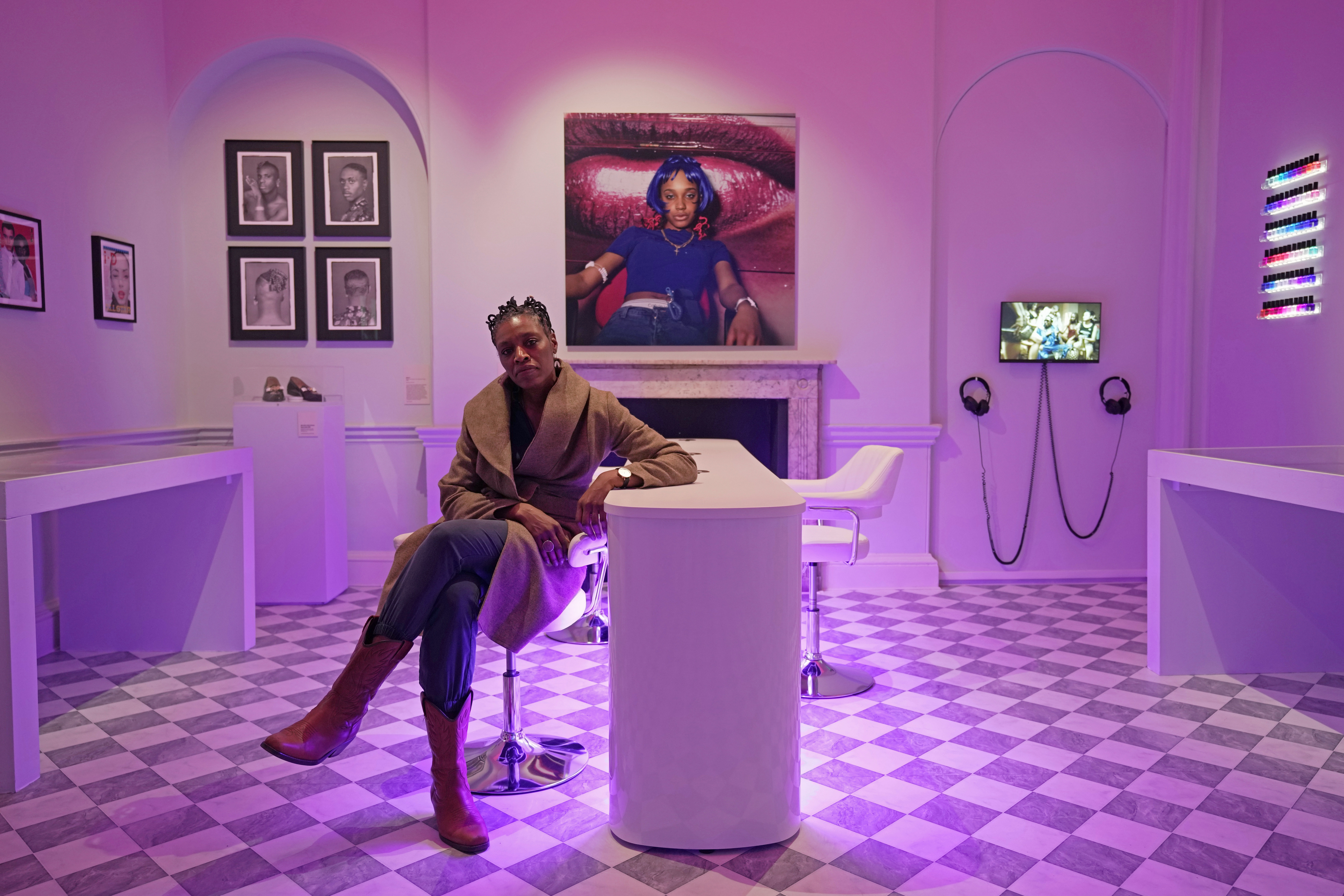 British photographer Eileen Perrier poses in front of her artwork during a preview of the exhibition titled "The Missing Thread: Untold Stories of Black British Fashion", at Somerset House, in London, Tuesday, Sept. 19, 2023. A new exhibition is opening in London to chart for the first time the contributions Black British culture made to U.K. fashion and design history and to celebrate Black designers who have not received public recognition. The exhibition opens on Thursday and pays tribute to the influence of Black designers in fashion from the 1970s. (AP Photo/Kin Cheung)