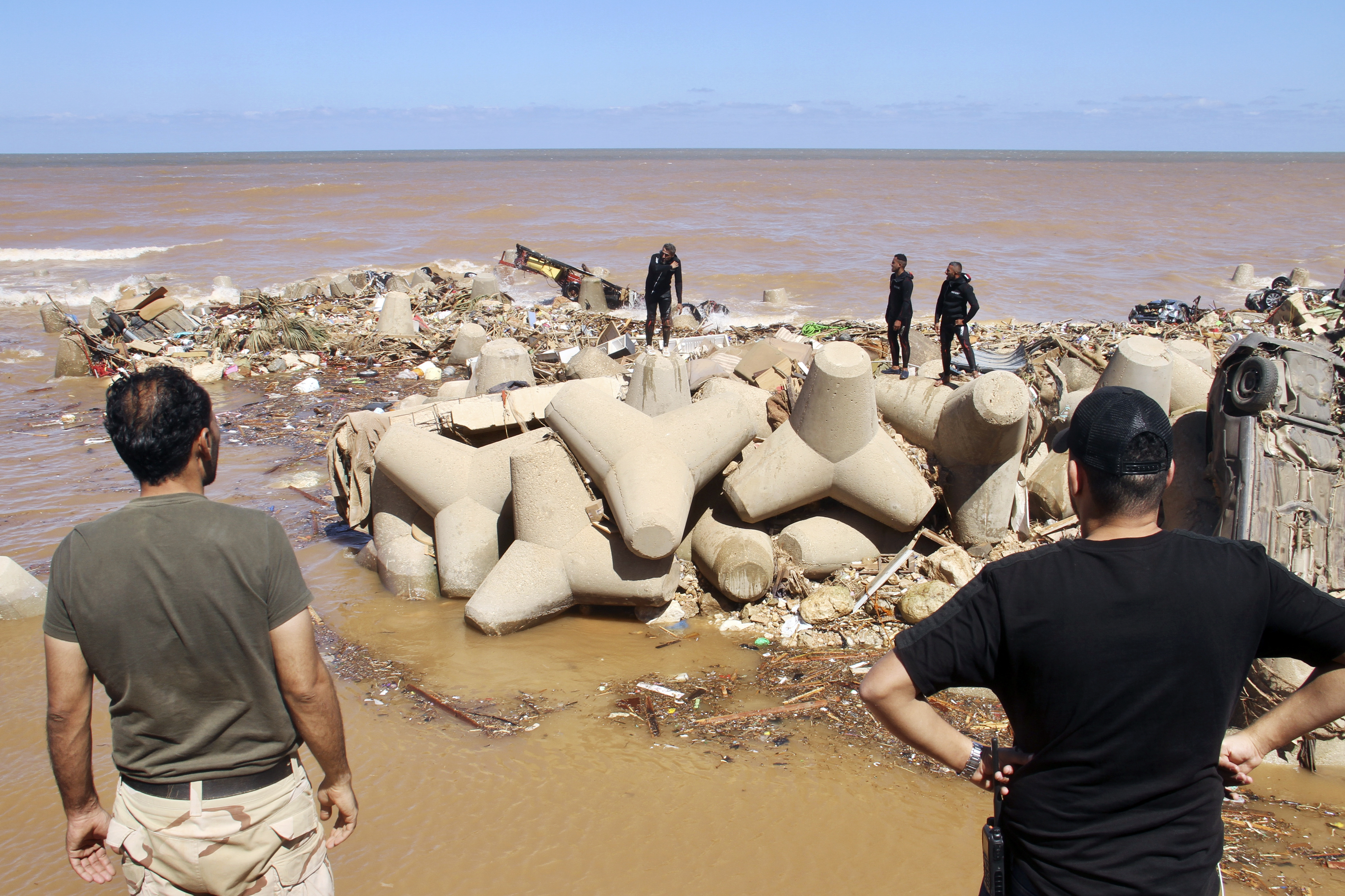 FILE - People look for survivors after flooding in Derna, Libya, Sept. 13, 2023. The devastating storm that dumped torrential rains along the Libyan coast this month was up to 50 times more likely to occur and 50% more intense because of human-caused climate change, according to an analysis released Tuesday, Sept. 19. (AP Photo/Yousef Murad, File)