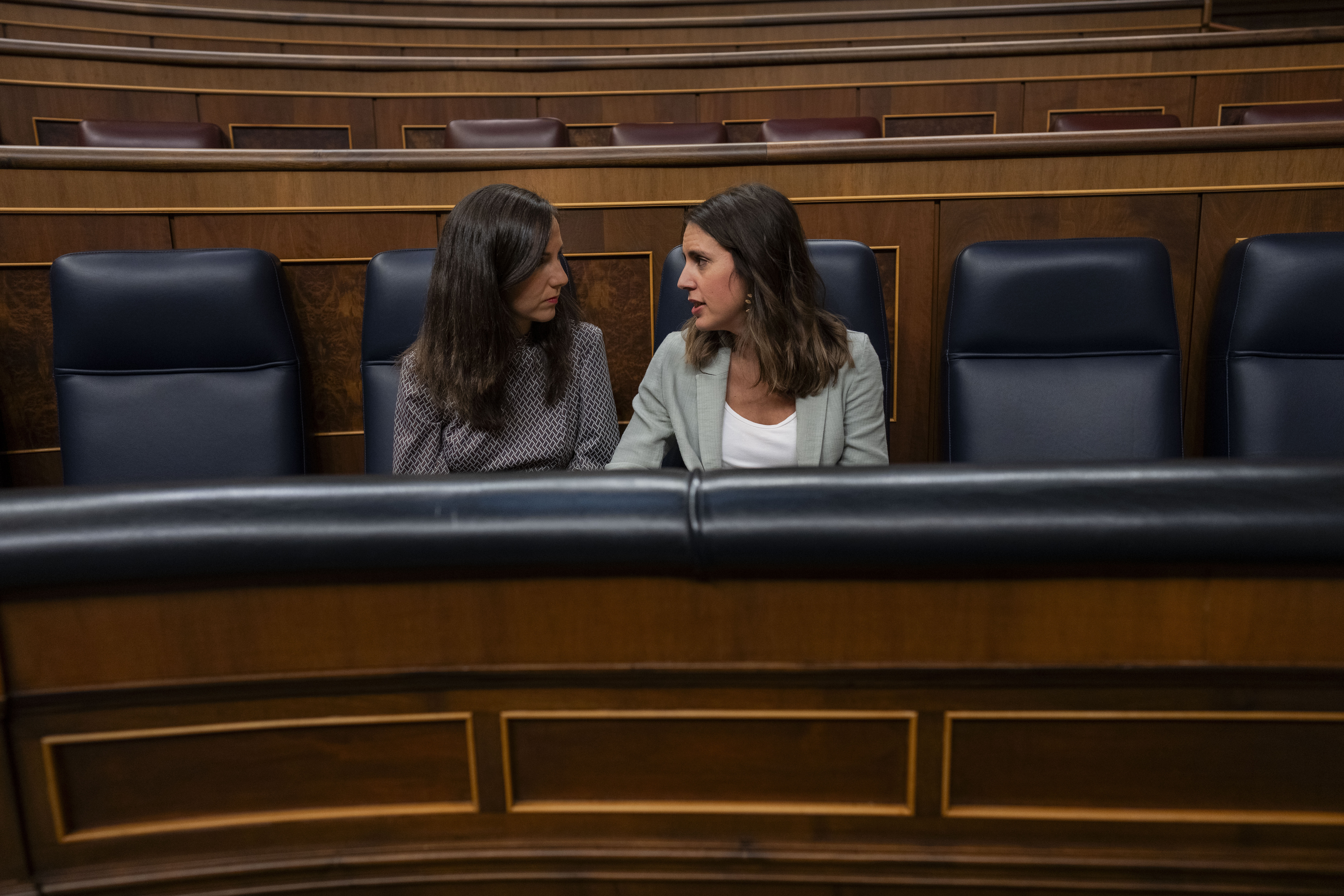 Ione Belarra, acting minister of social rights, left, and Irene Montero, acting minister of equality talk at the Spanish parliament's lower house in Madrid, Spain on Tuesday, Sept. 26, 2023. The leader of Spain's conservatives is trying to win the endorsement of the nation's Parliament to form a new government. Alberto Núñez Feijóo's Popular Party won the most seats after inconclusive July 23 national elections that left all parties well shy of an absolute majority. Feijóo faces two investiture votes — one on Wednesday and then again on Friday — that will determine whether he can become prime minister. (AP Photo/Bernat Armangue)