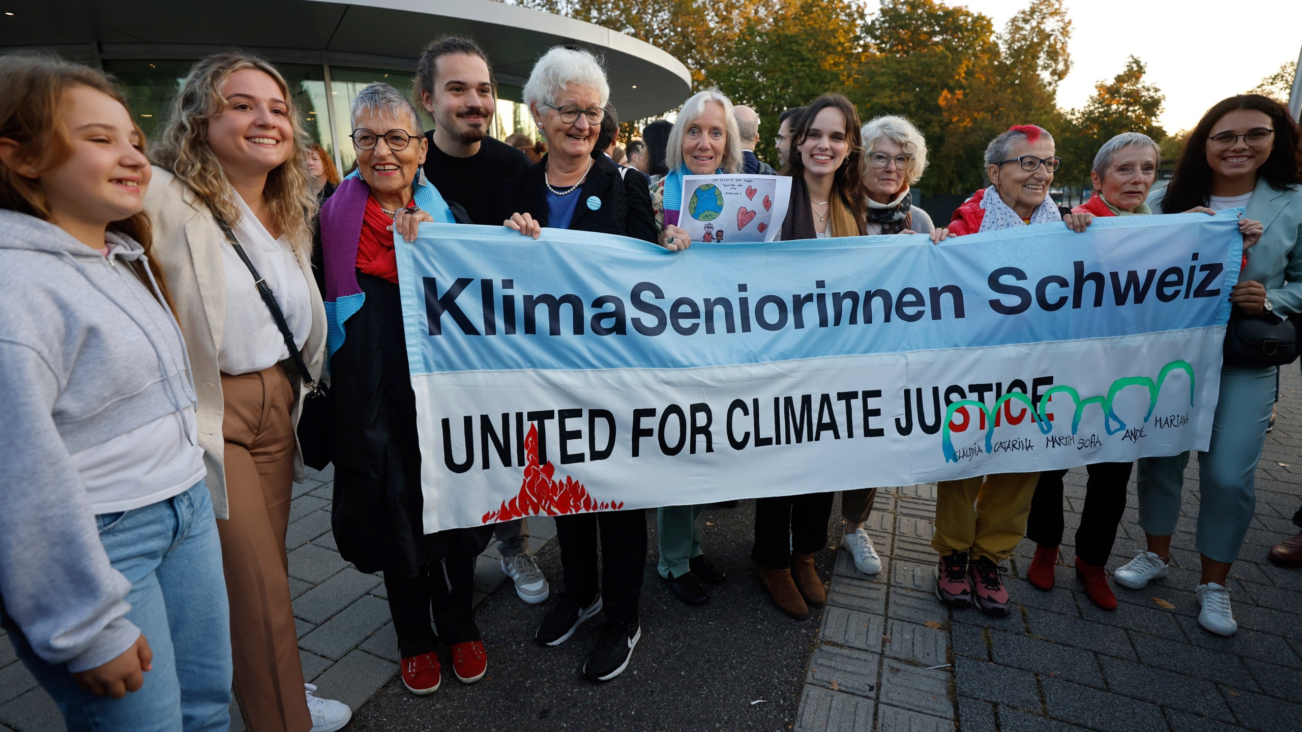 Catarine Mota, right, siblings Martim, Mariana and Claudia Agostinho, left, and Sofia Oliveira, center right, protest outside the European Court of Human Rights, where they are accusing 32 European governments of violating their human rights for what they say is a failure to adequately address climate change, Wednesday, Sept. 27, 2023, in Strasbourg. (AP Photo/Jean-Francois Badias)