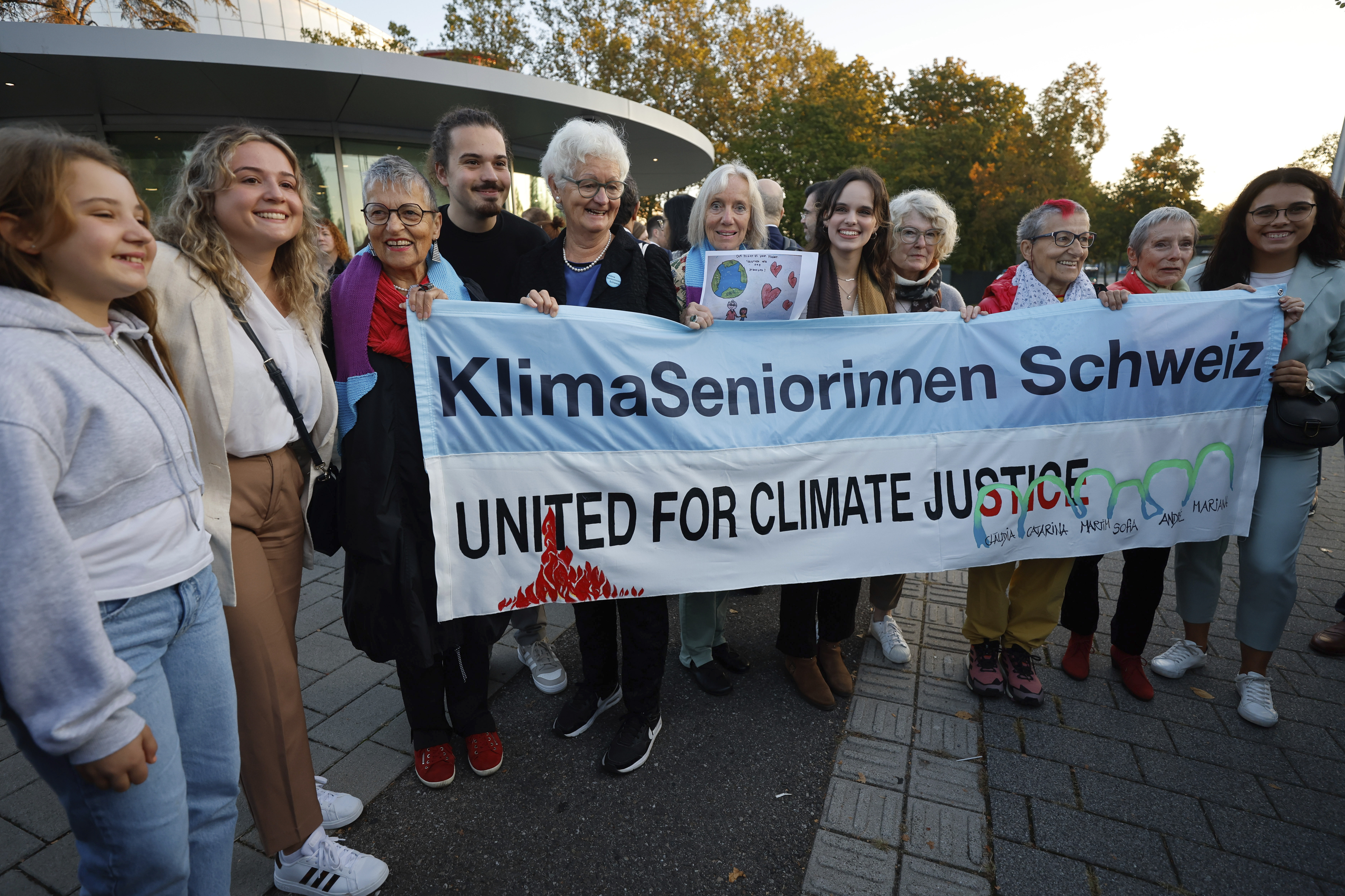 Catarine Mota, right, siblings Martim, Mariana and Claudia Agostinho, left, and Sofia Oliveira, center right, protest outside the European Court of Human Rights, where they are accusing 32 European governments of violating their human rights for what they say is a failure to adequately address climate change, Wednesday, Sept. 27, 2023, in Strasbourg. (AP Photo/Jean-Francois Badias)