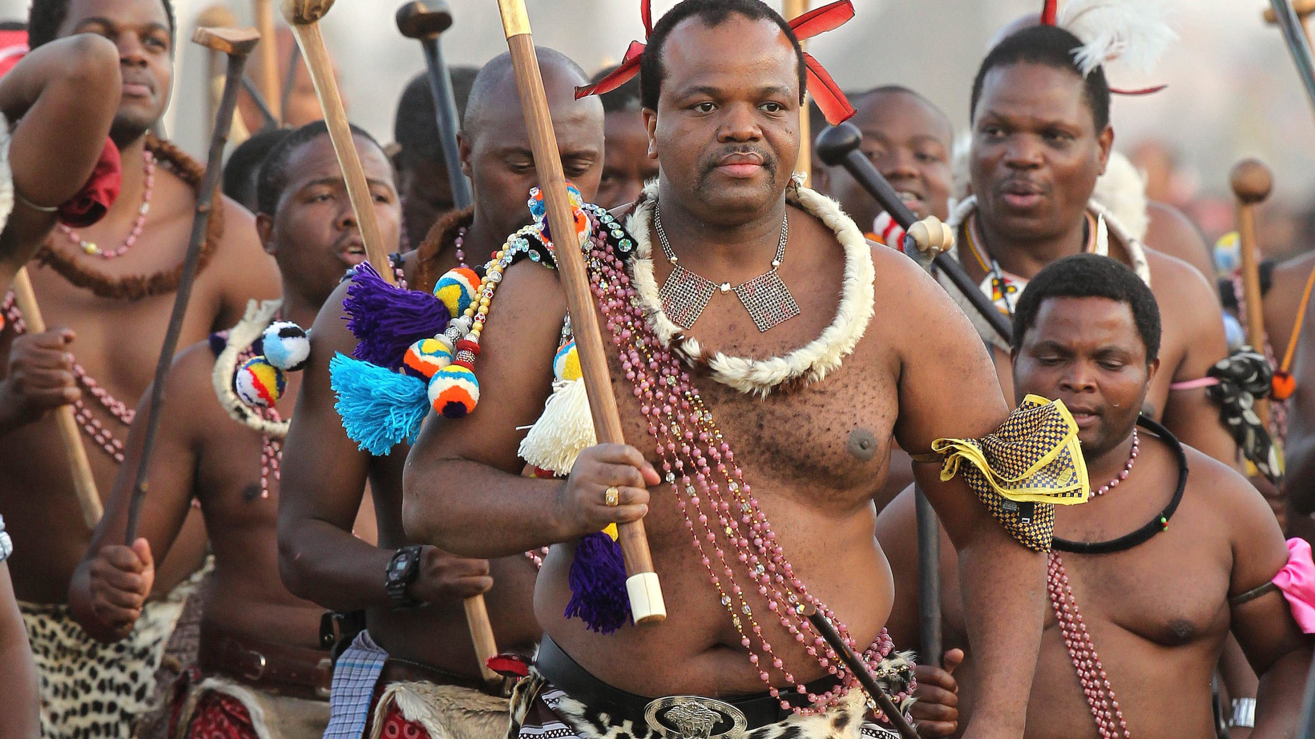 FILE - Eswatini's King Mswati III, center, dances during a Reed Dance in Mbabane, Swaziland, on Sept. 3, 2012. The small southern African nation of Eswatini was holding elections Friday Sept. 29, 2023 to decide part of the makeup of its parliament, even as the extremely wealthy king retains absolute power, political parties are banned and elected representatives can merely advise a monarch whose family has reigned supreme for 55 years. (AP Photo/Themba Hadebe, File)