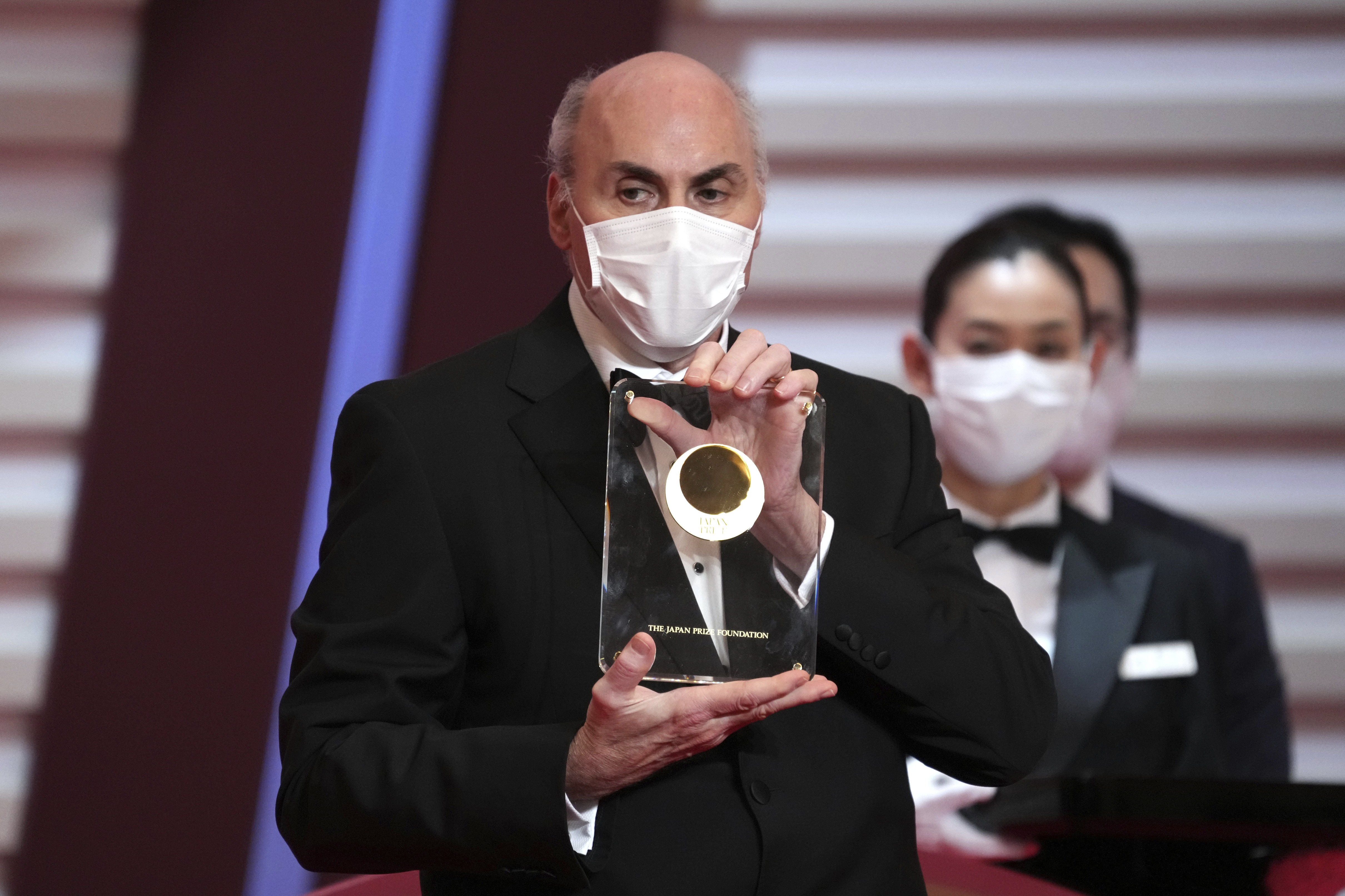 FILE - Japan Prize 2022 laureate, American physician-scientist Drew Weissman poses with his trophy during the Japan Prize presentation ceremony Wednesday, April 13, 2022, in Tokyo. Two scientists have won the Nobel Prize in medicine for discoveries that enabled the development of mRNA vaccines against COVID-19. The award was given to Katalin Karikó and Drew Weissman. Karikó is a professor at Sagan’s University in Hungary and an adjunct professor at the University of Pennsylvania. (AP Photo/Eugene Hoshiko, Pool, File)