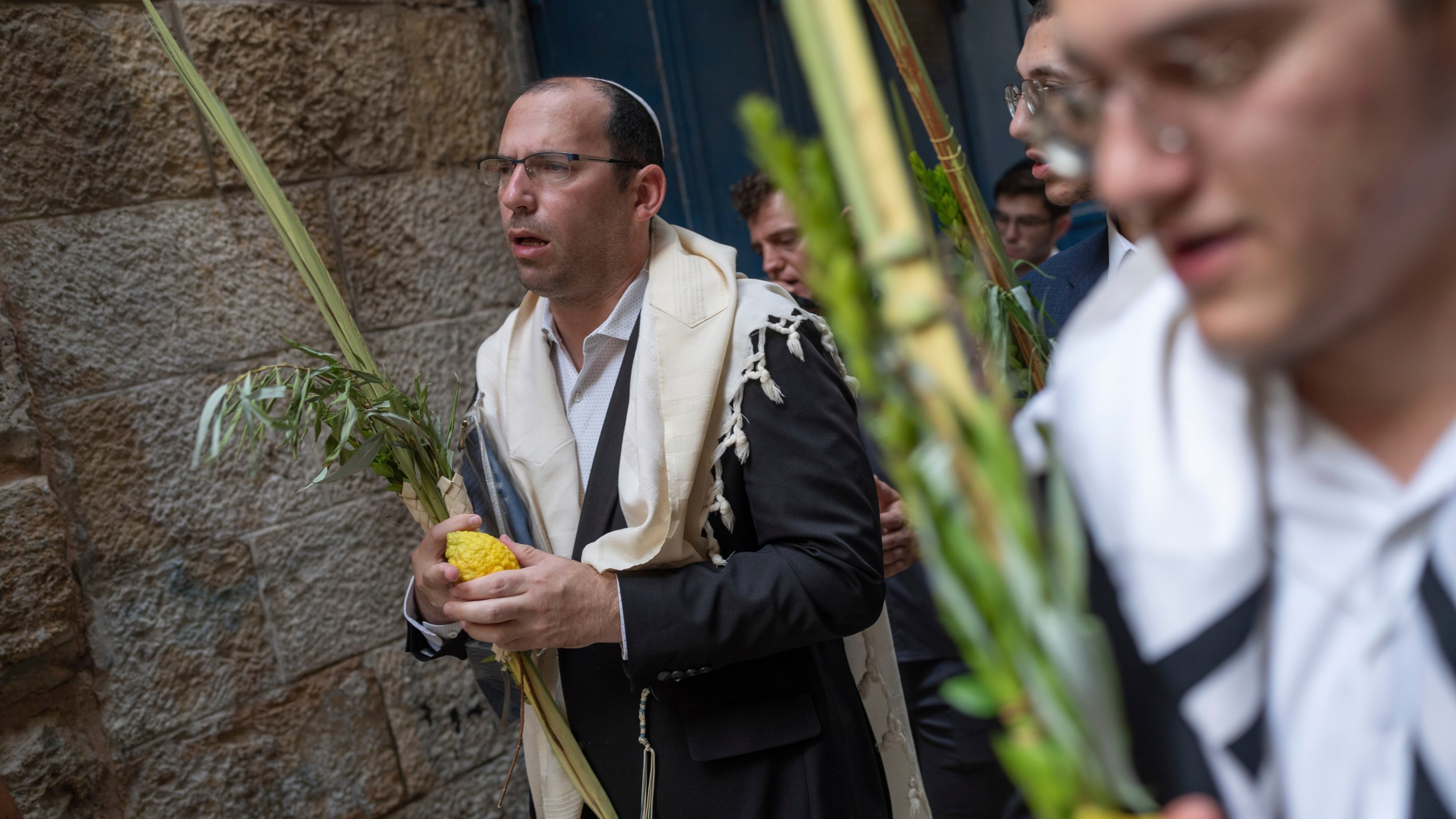 Israeli lawmaker Simcha Rothman takes part in a prayer during a weeklong Jewish holiday of Sukkot, next to one of the gates to the Temple Mount, known to Muslims as the Noble Sanctuary, or the Al-Aqsa Mosque compound, in the Old City of Jerusalem, Wednesday, Oct. 4, 2023. (AP Photo/Ohad Zwigenberg)