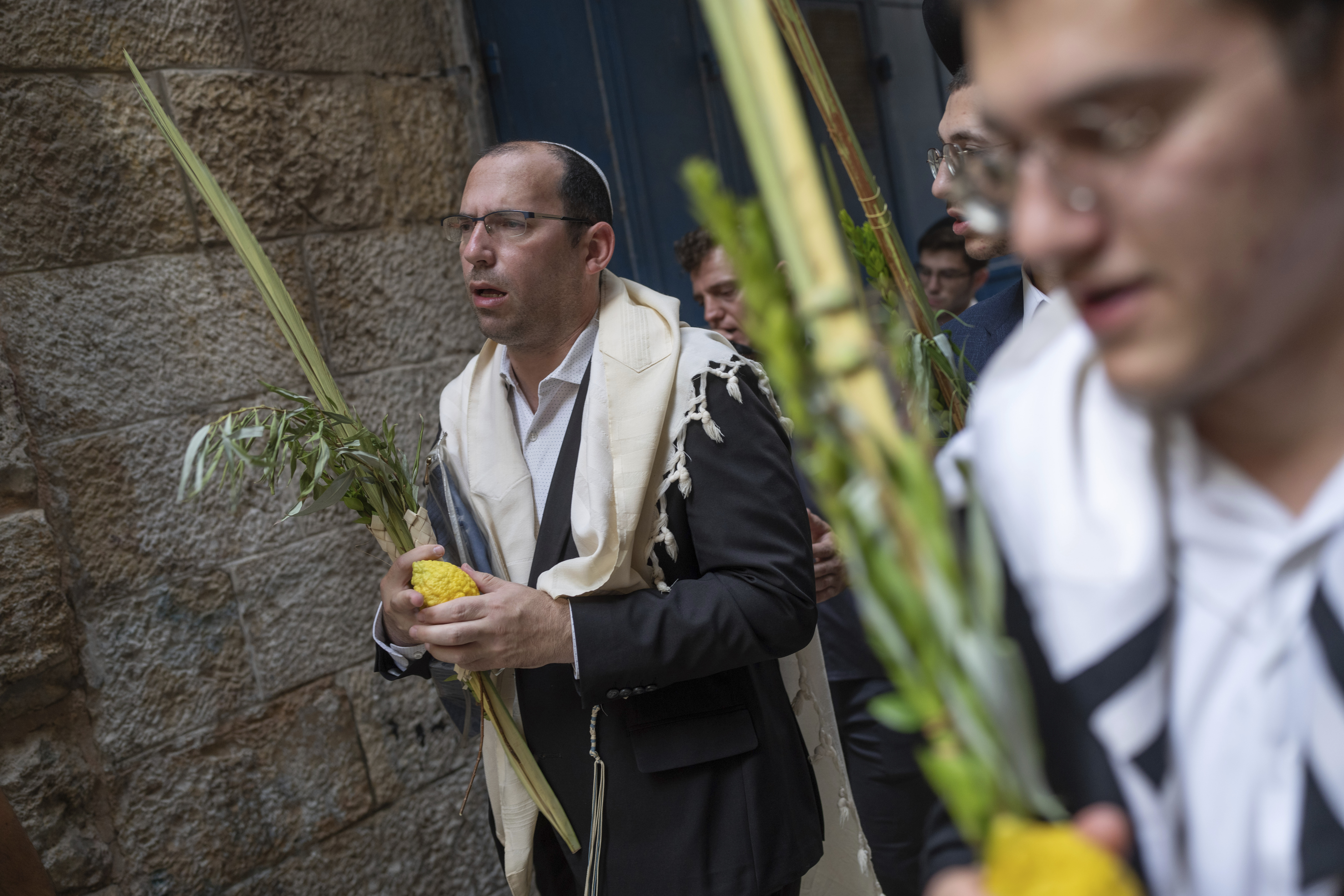 Israeli lawmaker Simcha Rothman takes part in a prayer during a weeklong Jewish holiday of Sukkot, next to one of the gates to the Temple Mount, known to Muslims as the Noble Sanctuary, or the Al-Aqsa Mosque compound, in the Old City of Jerusalem, Wednesday, Oct. 4, 2023. (AP Photo/Ohad Zwigenberg)