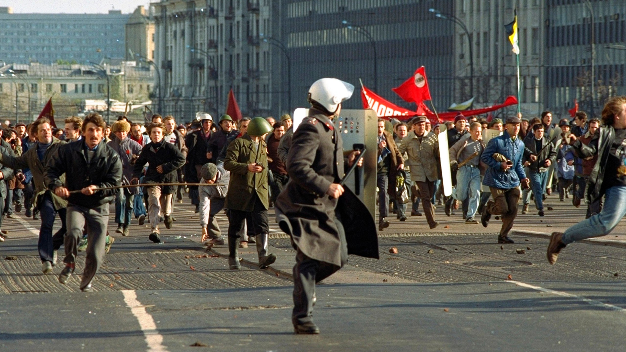 FILE - A militiaman is chased by a mob of hard-liners who forced their way through police blocks when making their way to the Russian White House in Moscow, on Oct. 3, 1993. The October 1993 violent showdown between the Kremlin and supporters of the rebellious parliament marked a watershed in Russia's post-Soviet history. (AP Photo/Alexander Zemlianichenko, File)