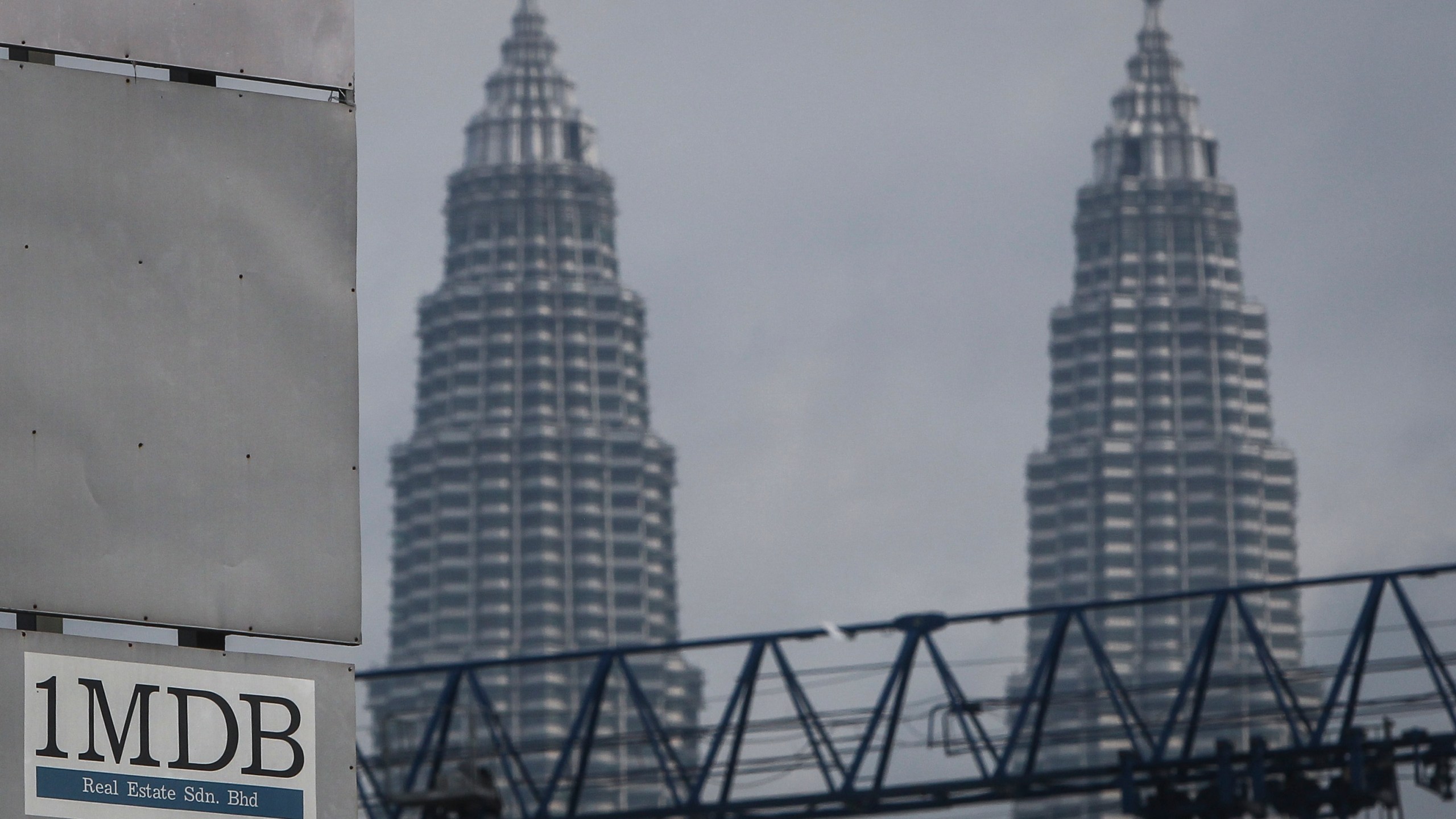 FILE - In this Wednesday, July 8, 2015 photo, a 1MDB (1 Malaysia Development Berhad) logo is set against the Petronas Twin Towers at the flagship development site, Tun Razak Exchange in Kuala Lumpur, Malaysia. The Malaysian government questioned Thursday, Oct. 12, 2023, a move by Goldman Sachs to file for arbitration in a dispute over a settlement of a case involving the multibillion-dollar looting of a sovereign wealth fund. (AP Photo/Joshua Paul, File)