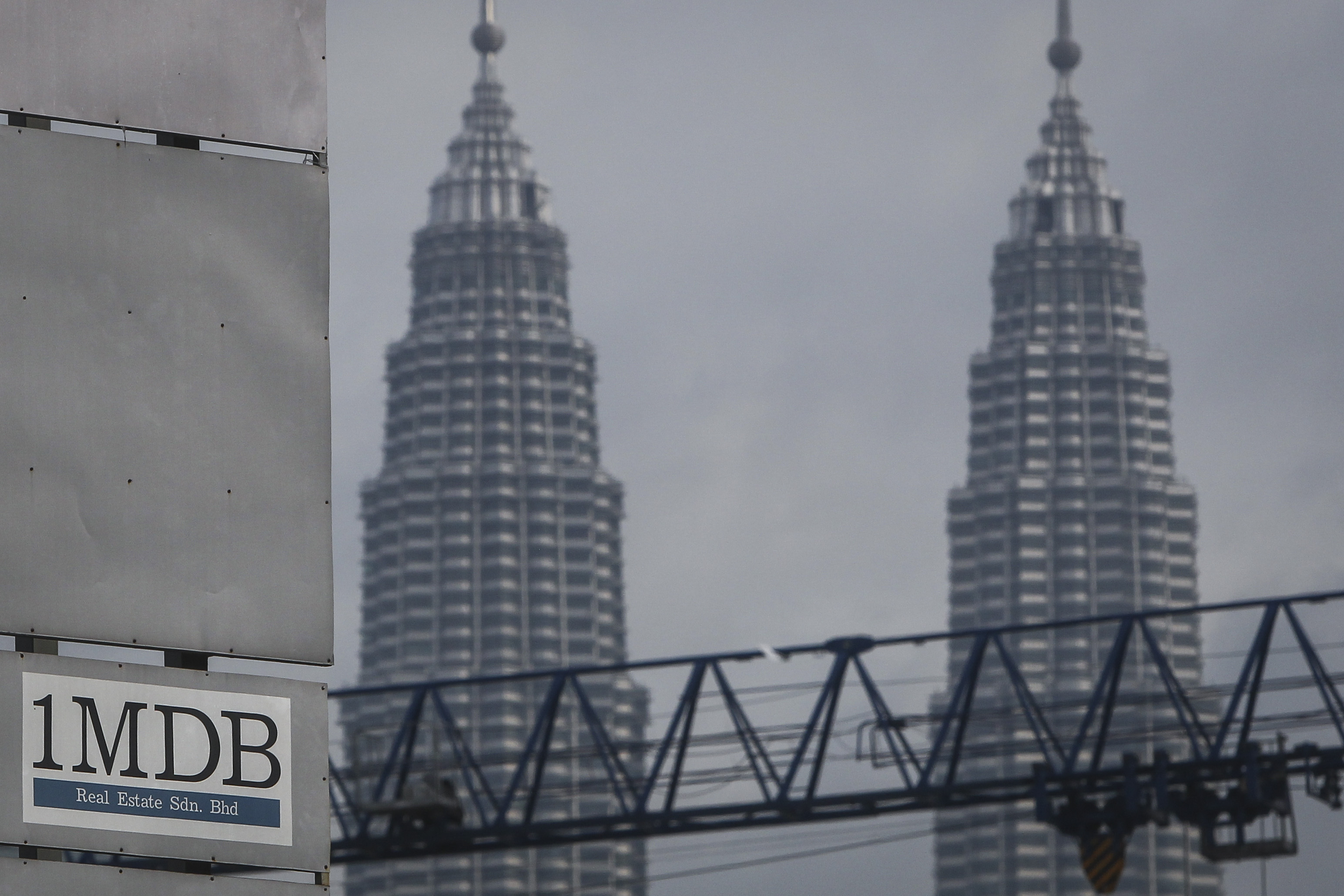 FILE - In this Wednesday, July 8, 2015 photo, a 1MDB (1 Malaysia Development Berhad) logo is set against the Petronas Twin Towers at the flagship development site, Tun Razak Exchange in Kuala Lumpur, Malaysia. The Malaysian government questioned Thursday, Oct. 12, 2023, a move by Goldman Sachs to file for arbitration in a dispute over a settlement of a case involving the multibillion-dollar looting of a sovereign wealth fund. (AP Photo/Joshua Paul, File)