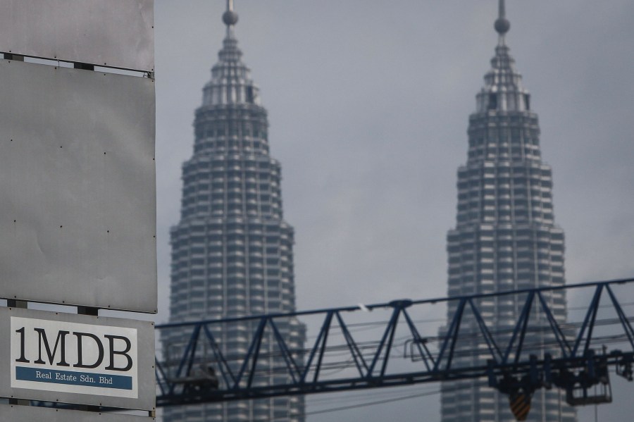 FILE - In this Wednesday, July 8, 2015 photo, a 1MDB (1 Malaysia Development Berhad) logo is set against the Petronas Twin Towers at the flagship development site, Tun Razak Exchange in Kuala Lumpur, Malaysia. The Malaysian government questioned Thursday, Oct. 12, 2023, a move by Goldman Sachs to file for arbitration in a dispute over a settlement of a case involving the multibillion-dollar looting of a sovereign wealth fund. (AP Photo/Joshua Paul, File)