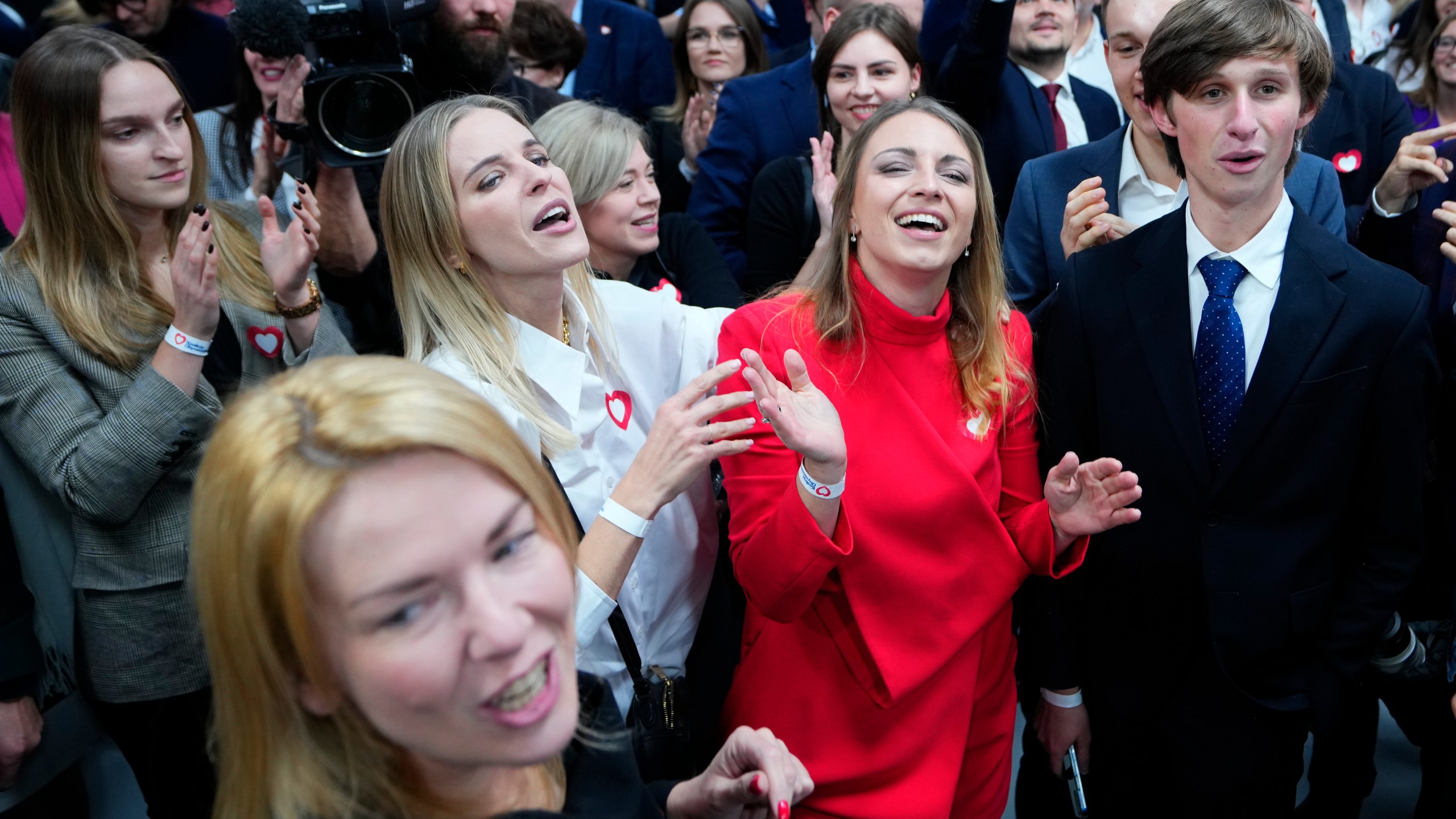 Supporters of Donald Tusk, a former Polish prime minister celebrate at his party headquarters in Warsaw, Poland, Sunday, Oct. 15, 2023. Poland's election result is on a knife edge as an exit poll says that the governing Law and Justice party won the most votes. (AP Photo/Petr David Josek)