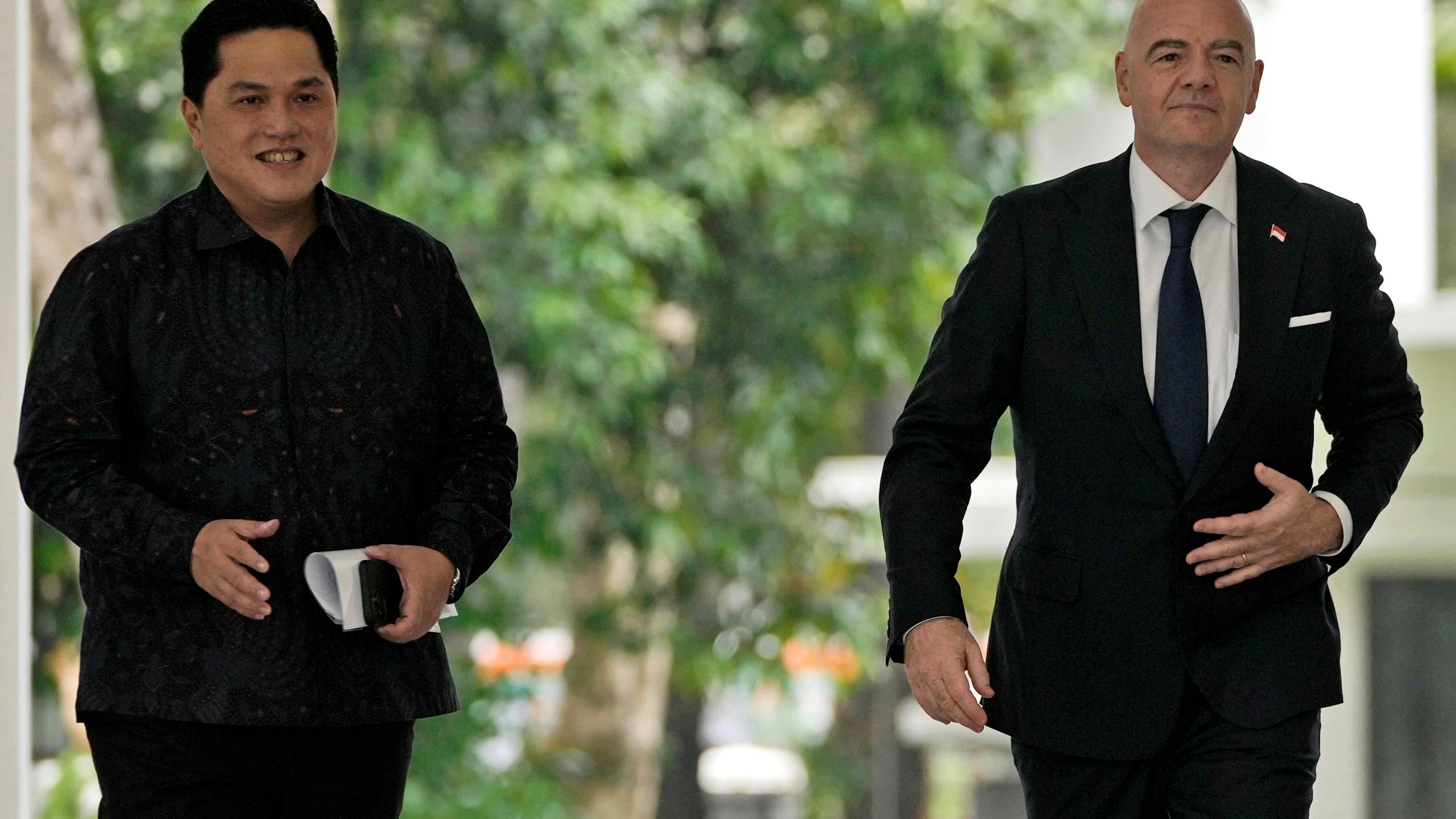 FILE - FIFA President Gianni Infantino, right, walks with Minister for State Owned Enterprises Erick Thohir upon arrival for a meeting with Indonesian President Joko Widodo at Merdeka Palace in Jakarta, Indonesia, Tuesday, Oct. 18, 2022. Indonesian soccer federation leader Erick Thohir says it now supports Saudi Arabia's bid to host the 2034 World Cup. (AP Photo/Achmad Ibrahim, File)