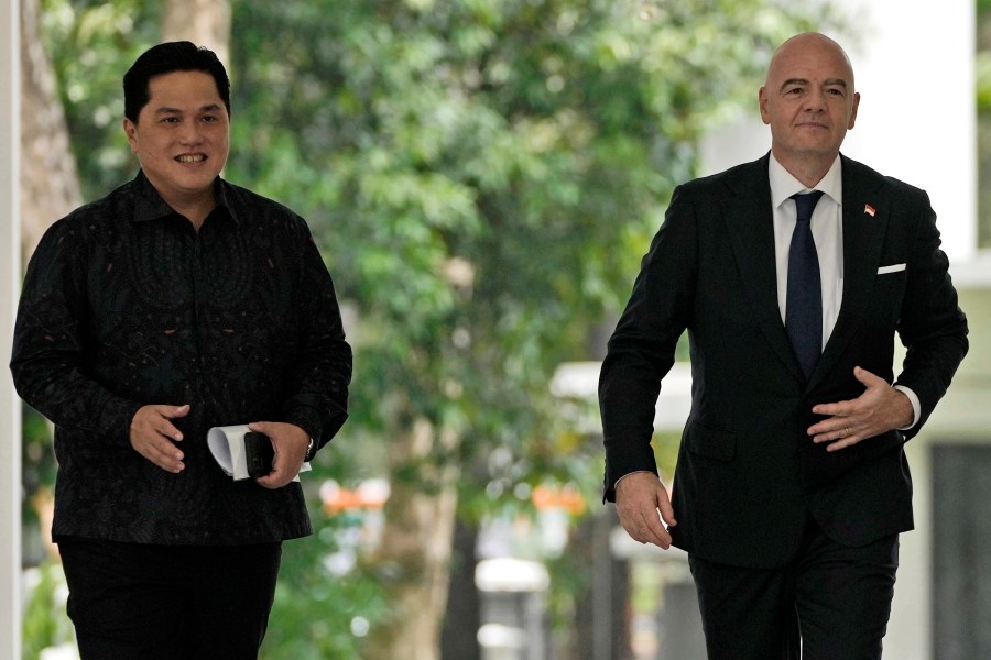 FILE - FIFA President Gianni Infantino, right, walks with Minister for State Owned Enterprises Erick Thohir upon arrival for a meeting with Indonesian President Joko Widodo at Merdeka Palace in Jakarta, Indonesia, Tuesday, Oct. 18, 2022. Indonesian soccer federation leader Erick Thohir says it now supports Saudi Arabia's bid to host the 2034 World Cup. (AP Photo/Achmad Ibrahim, File)