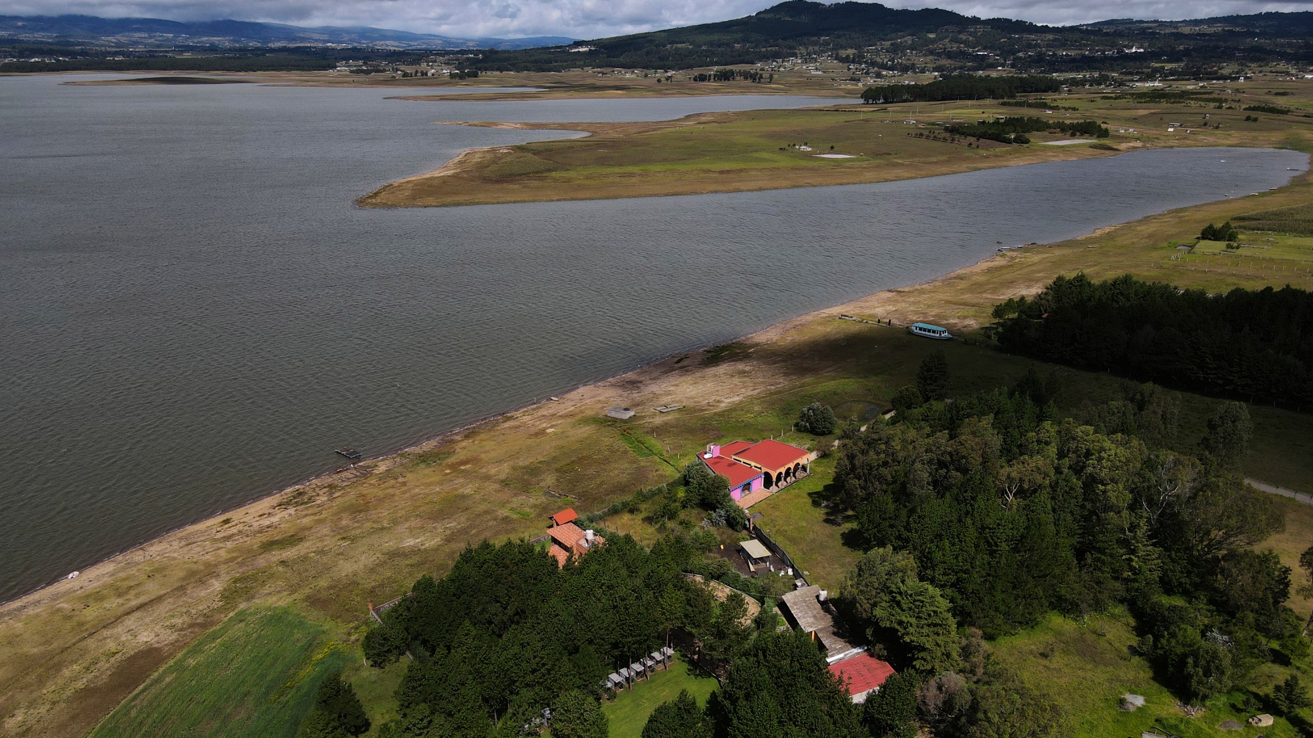 The banks of the Villa Victoria reservoir are exposed due to low water levels in the state of Mexico, Tuesday, Oct. 10, 2023. The capital’s reservoirs like Villa Victoria are running historically low following a “too dry” summer, according to official data, and as the rainy season draws to a close, water restrictions have already begun. (AP Photo/Marco Ugarte)