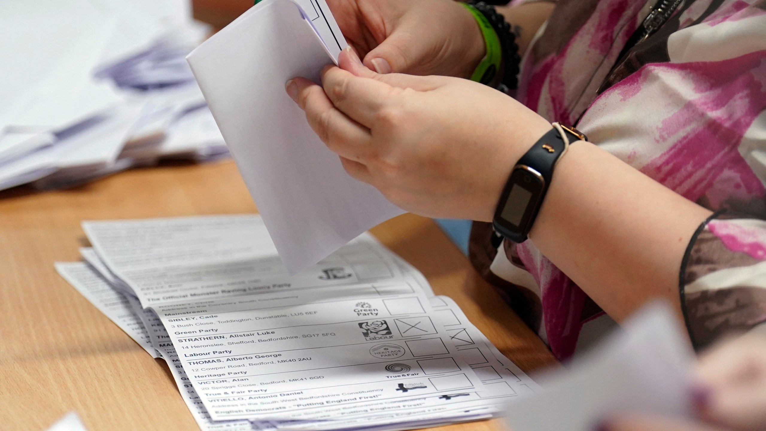 Ballot papers are verified at Priory House in Chicksands, Bedfordshire, England, during the count for the Mid Bedfordshire by-election, Thursday, Oct. 19, 2023. (Joe Giddens/PA via AP)