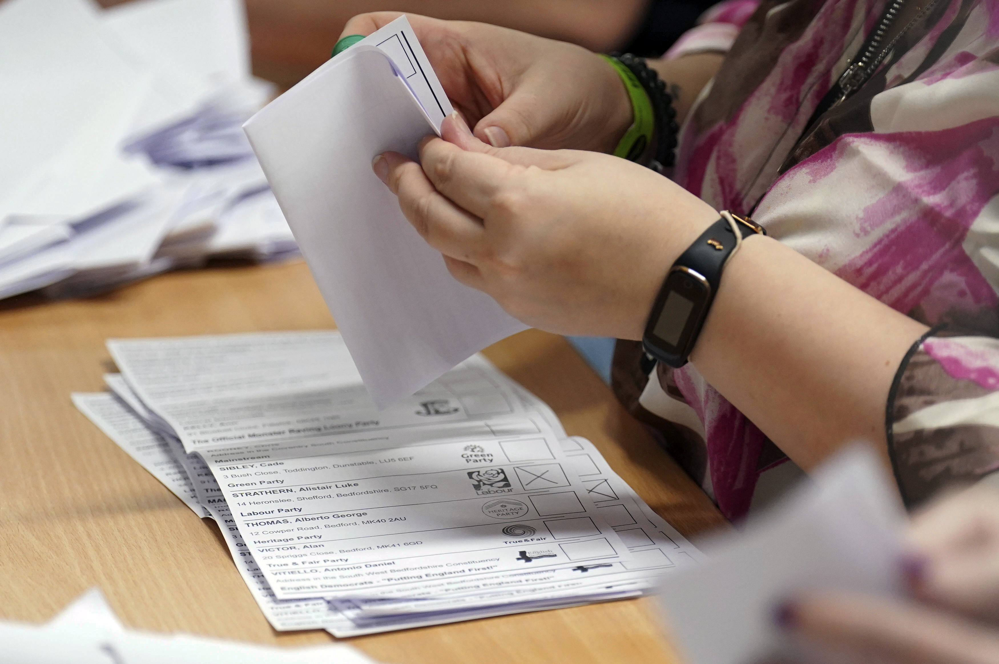 Ballot papers are verified at Priory House in Chicksands, Bedfordshire, England, during the count for the Mid Bedfordshire by-election, Thursday, Oct. 19, 2023. (Joe Giddens/PA via AP)