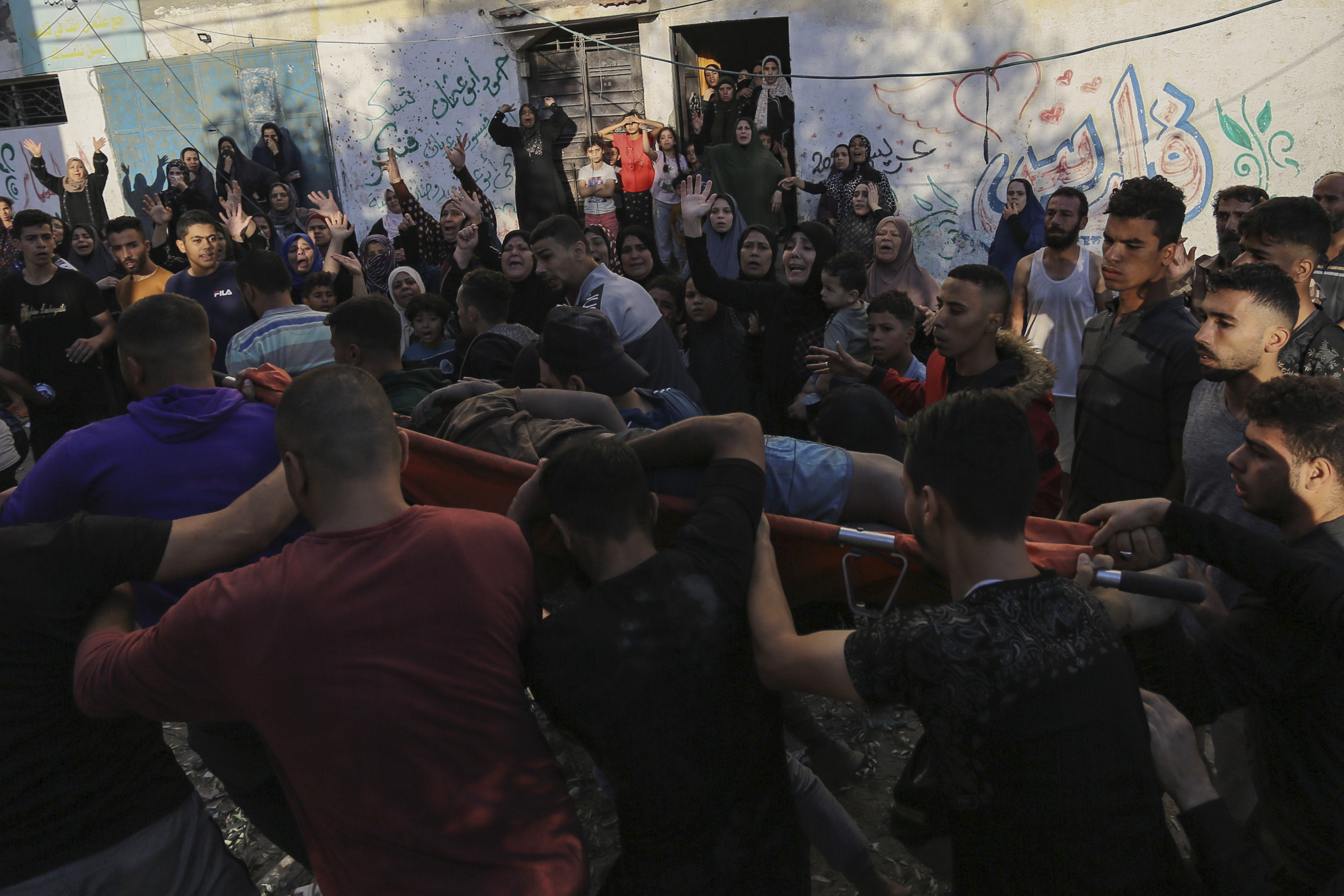 Palestinian women react as a body is carried out from the rubble of a destroyed house following Israeli airstrikes on Gaza City, Saturday, Oct. 21, 2023. (AP Photo/Abed Khaled)