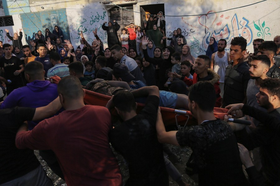 Palestinian women react as a body is carried out from the rubble of a destroyed house following Israeli airstrikes on Gaza City, Saturday, Oct. 21, 2023. (AP Photo/Abed Khaled)