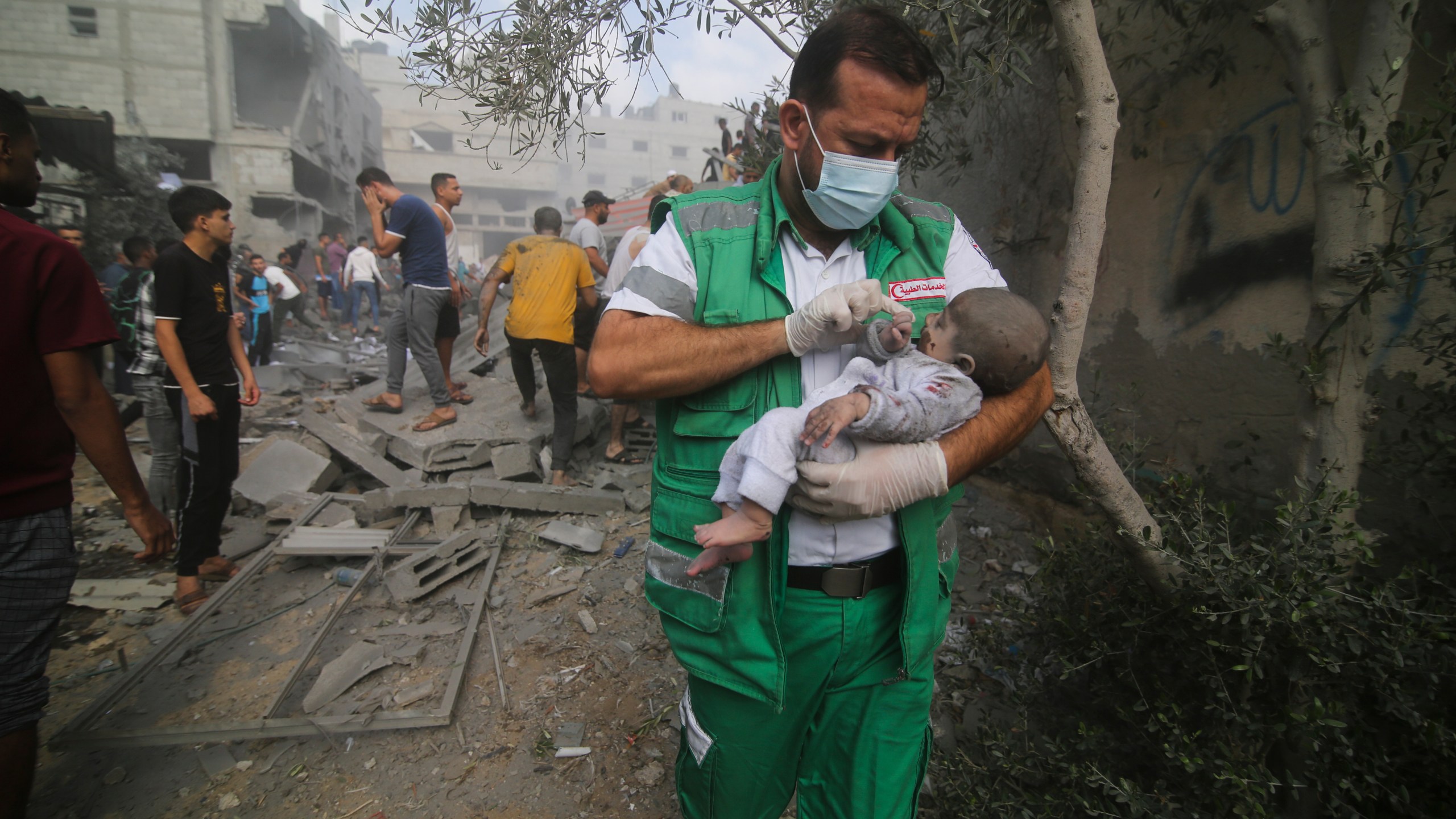 Palestinian medic takes a baby pulled out of buildings destroyed in the Israeli bombardment of the Gaza Strip in Rafah, Sunday, Oct. 22, 2023. (AP Photo/Hatem Ali)