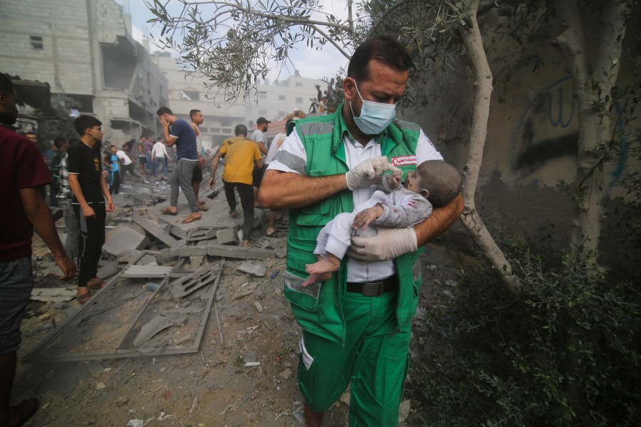 Palestinian medic takes a baby pulled out of buildings destroyed in the Israeli bombardment of the Gaza Strip in Rafah, Sunday, Oct. 22, 2023. (AP Photo/Hatem Ali)