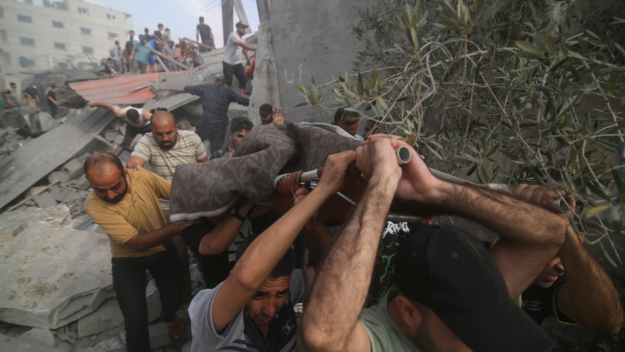 Palestinians are evacuated from buildings hit in the Israeli bombardment of the Gaza Strip in Rafah, Sunday, Oct. 22, 2023. (AP Photo/Hatem Ali)