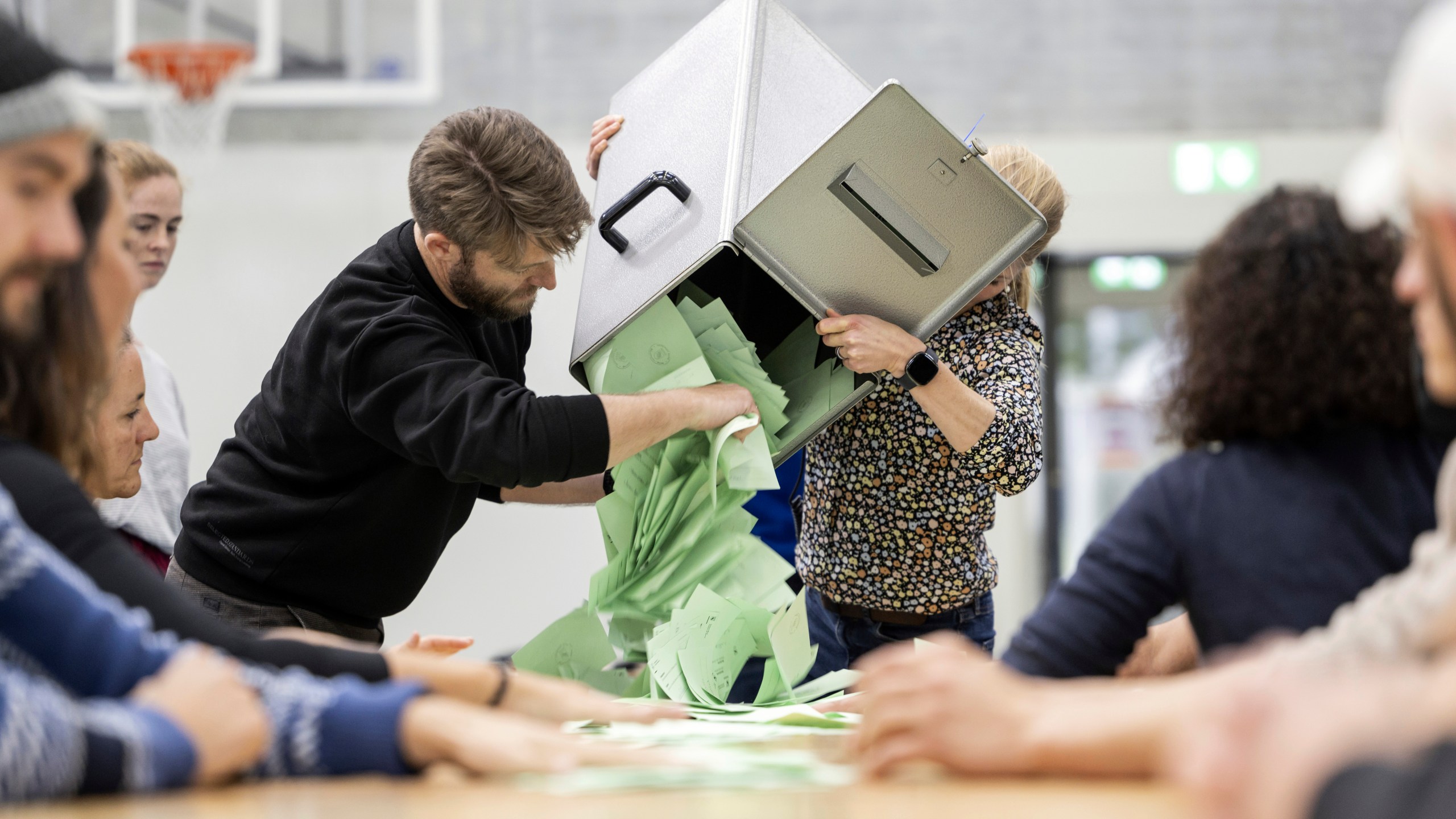 Election counting staff empty a ballot box to begin counting votes at a polling station in Berne, Switzerland, Sunday, Oct. 22, 2023. The anti-immigration Swiss People’s Party rebounded from searing losses four years ago, expanding its hold as the largest parliamentary faction, while environmentally-minded parties lost ground despite record glacier melt in the Alpine country, official election results showed. (Alessandro della Valle/Keystone via AP)