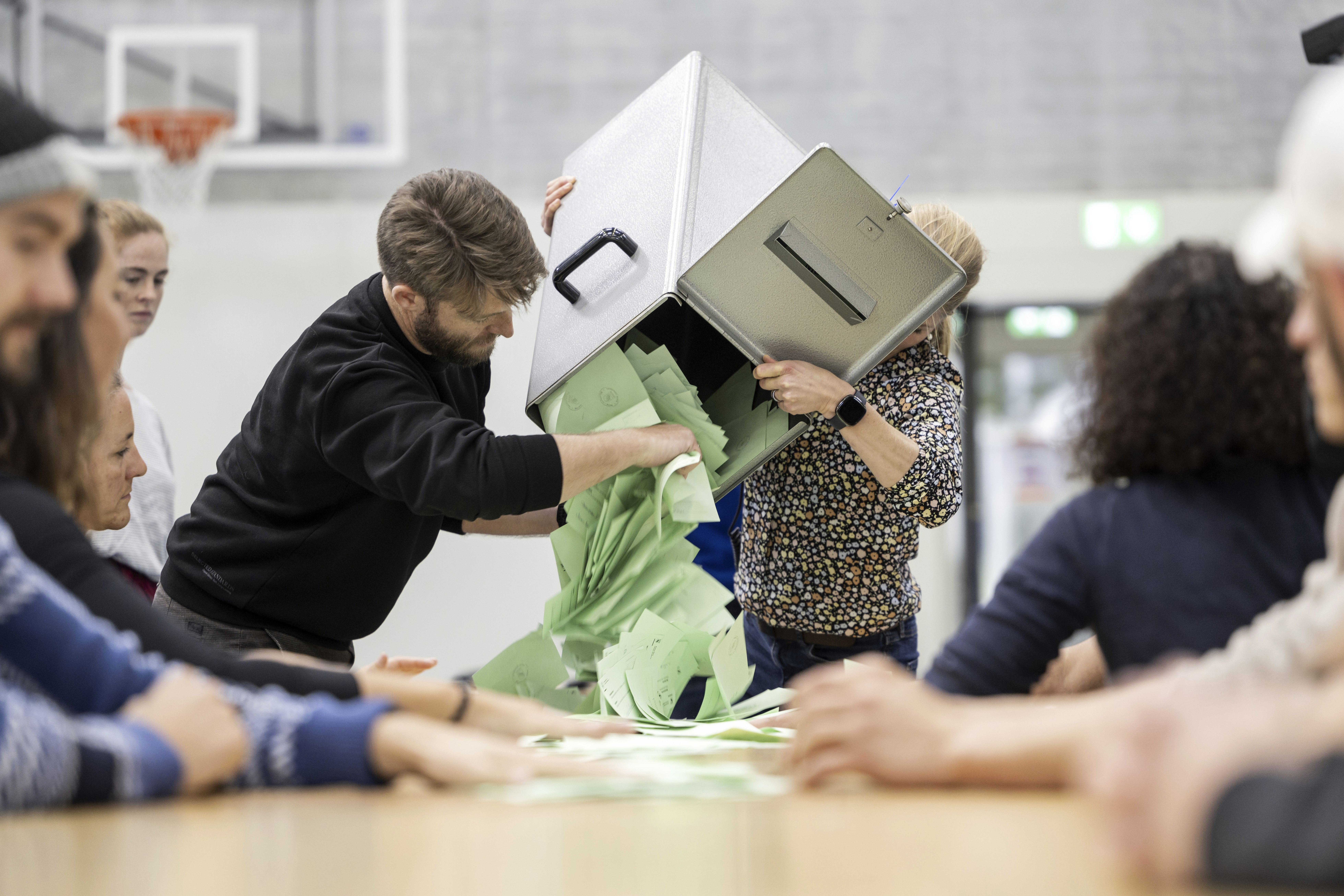 Election counting staff empty a ballot box to begin counting votes at a polling station in Berne, Switzerland, Sunday, Oct. 22, 2023. The anti-immigration Swiss People’s Party rebounded from searing losses four years ago, expanding its hold as the largest parliamentary faction, while environmentally-minded parties lost ground despite record glacier melt in the Alpine country, official election results showed. (Alessandro della Valle/Keystone via AP)