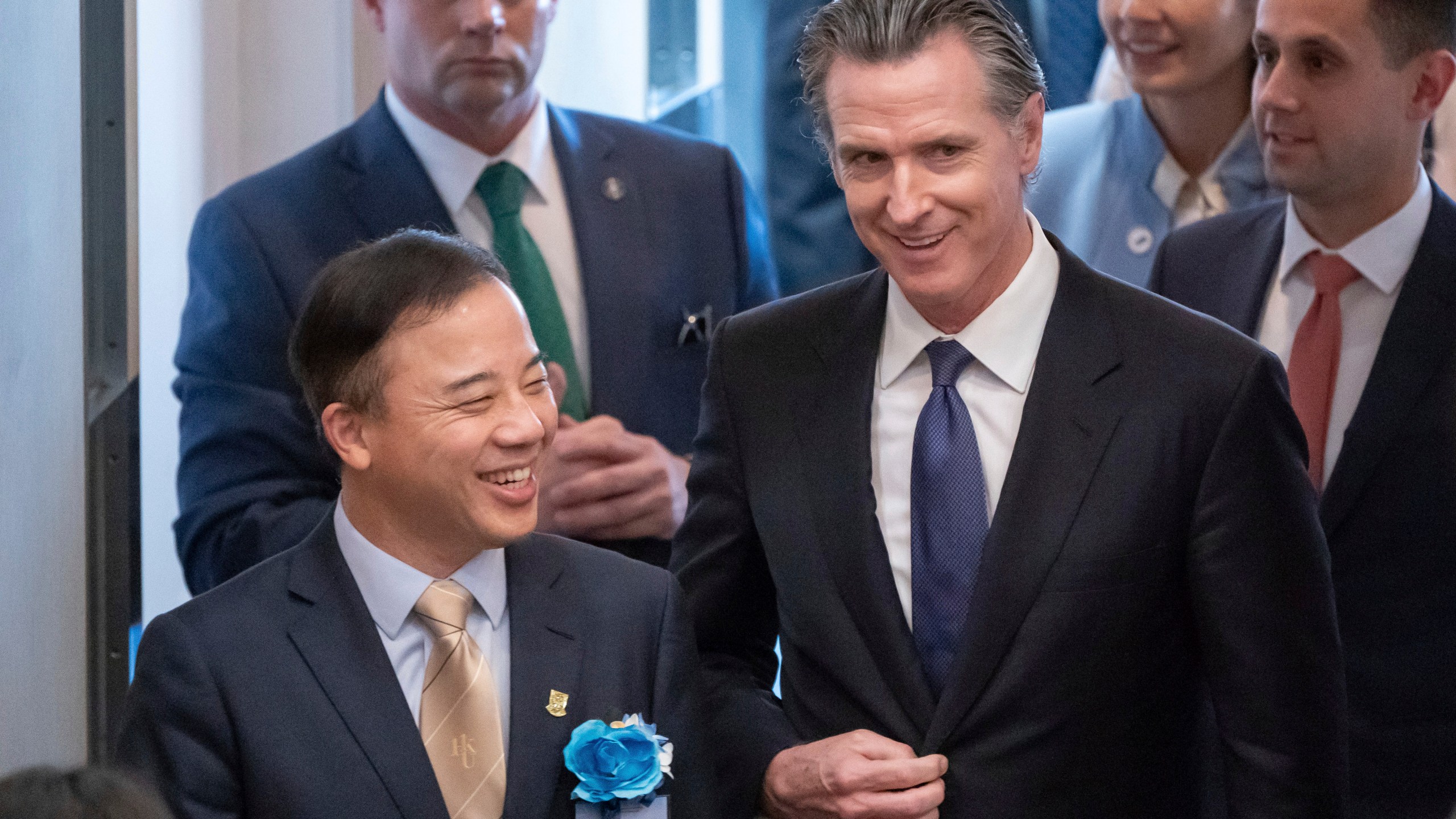 Visiting California Gov. Gavin Newsom, right, and President and Vice-Chancellor of the University of Hong Kong Xiang Zhang, left, arrive at the fireside chat at the Hong Kong University in Hong Kong, Monday, Oct. 23, 2023. The Governor of California said on Monday his state will always be a partner on climate issues no matter how the U.S. presidential election next year turns out during his week-long trip to China, in an attempt to reinforce his region's role as a global leader on climate change. (AP Photo/Anthony Kwan)