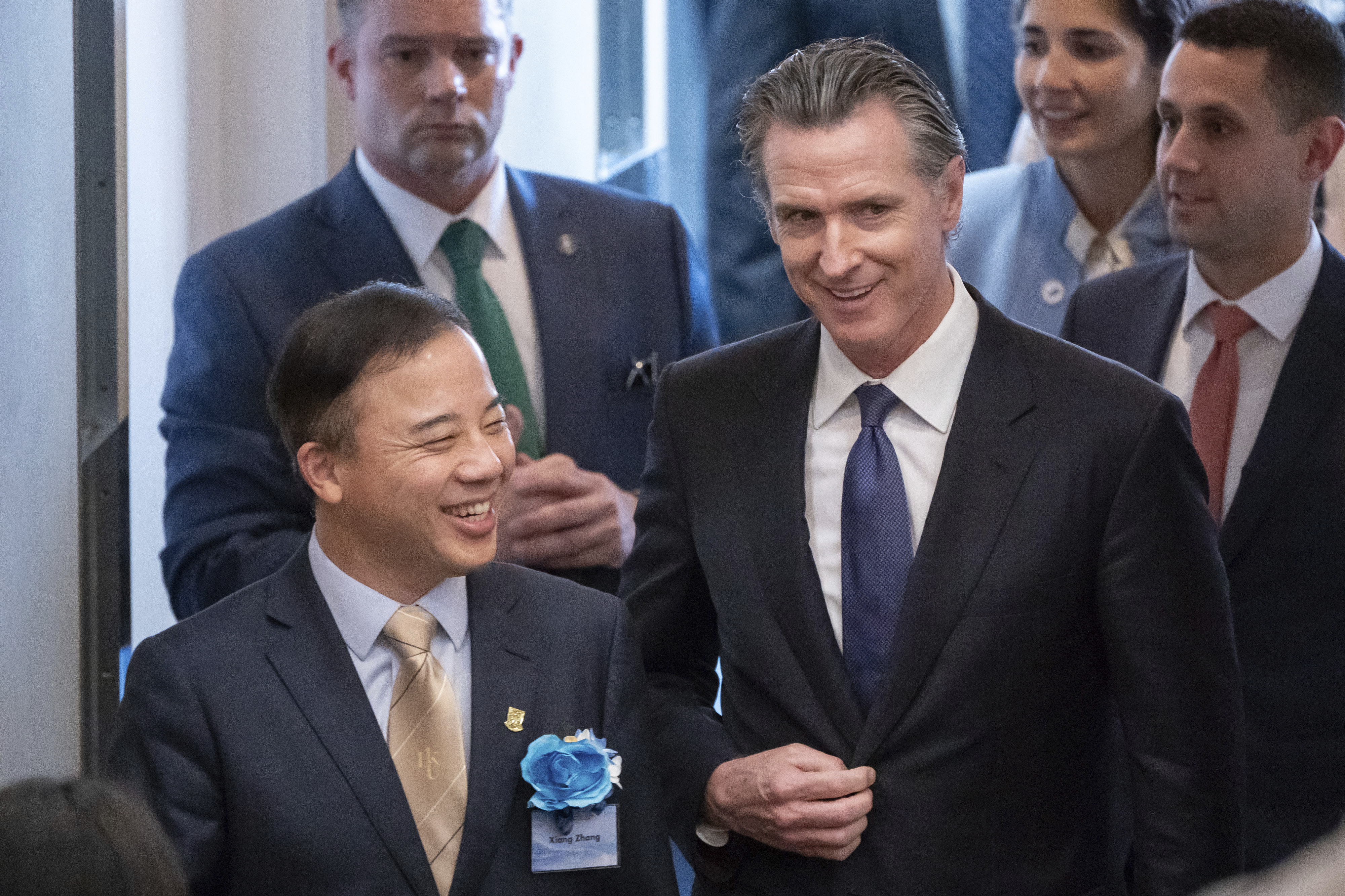 Visiting California Gov. Gavin Newsom, right, and President and Vice-Chancellor of the University of Hong Kong Xiang Zhang, left, arrive at the fireside chat at the Hong Kong University in Hong Kong, Monday, Oct. 23, 2023. The Governor of California said on Monday his state will always be a partner on climate issues no matter how the U.S. presidential election next year turns out during his week-long trip to China, in an attempt to reinforce his region's role as a global leader on climate change. (AP Photo/Anthony Kwan)