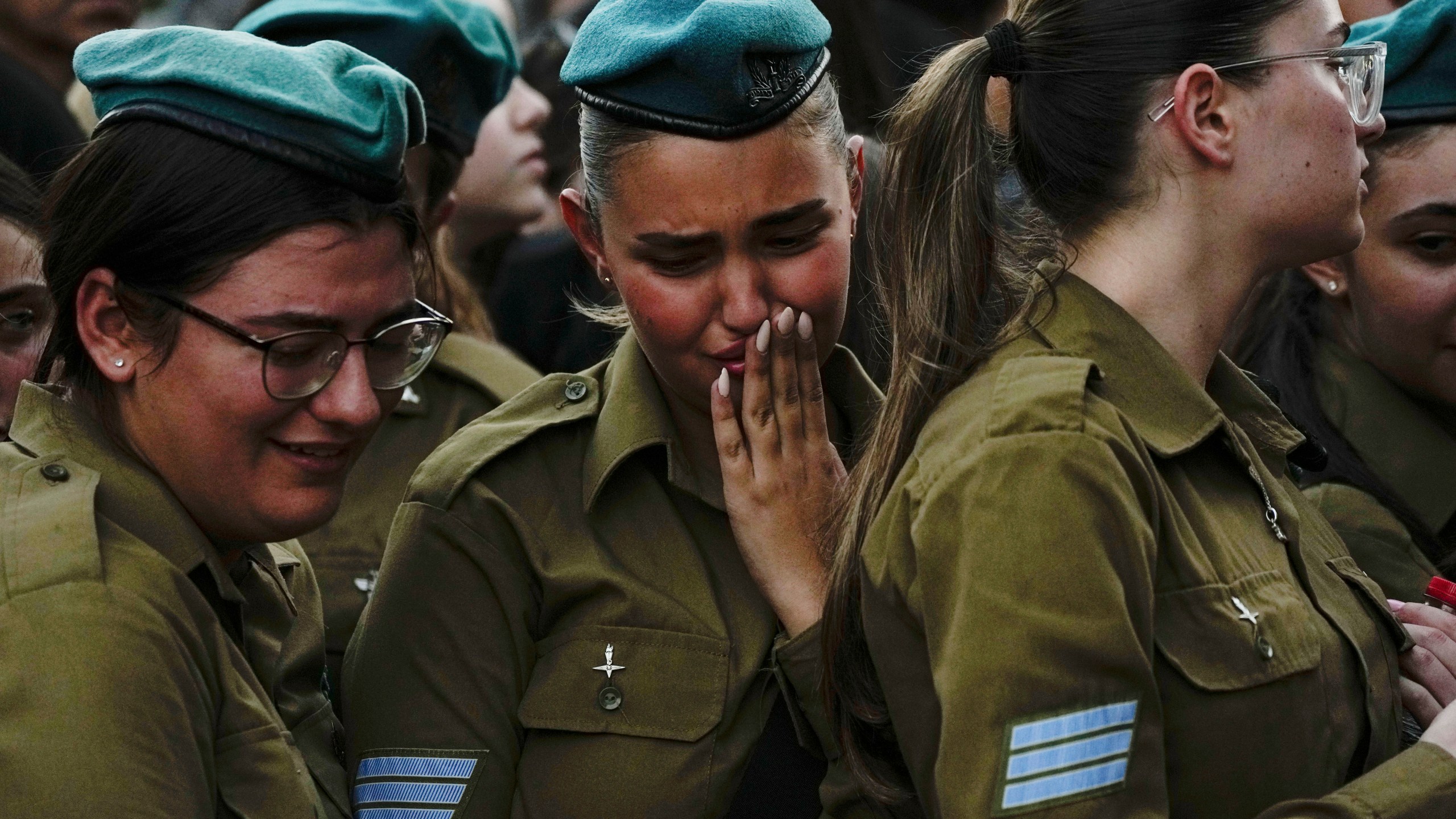 Israeli soldiers mourn during the funeral of Sgt. Yam Goldstein and her father, Nadav, in Kibbutz Shefayim, Israel, Monday, Oct. 23, 2023. Yam and her father were killed by Hamas militants on Oct. 7 at their house in Kibbutz Kfar Azza near the border with the Gaza Strip. The rest of the family are believed to be held hostage in Gaza. More than 1,400 people were killed and some 200 captured in an unprecedented, multi-front attack by the militant group that rules Gaza. (AP Photo/Ariel Schalit)