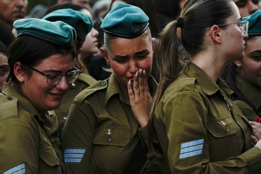 Israeli soldiers mourn during the funeral of Sgt. Yam Goldstein and her father, Nadav, in Kibbutz Shefayim, Israel, Monday, Oct. 23, 2023. Yam and her father were killed by Hamas militants on Oct. 7 at their house in Kibbutz Kfar Azza near the border with the Gaza Strip. The rest of the family are believed to be held hostage in Gaza. More than 1,400 people were killed and some 200 captured in an unprecedented, multi-front attack by the militant group that rules Gaza. (AP Photo/Ariel Schalit)