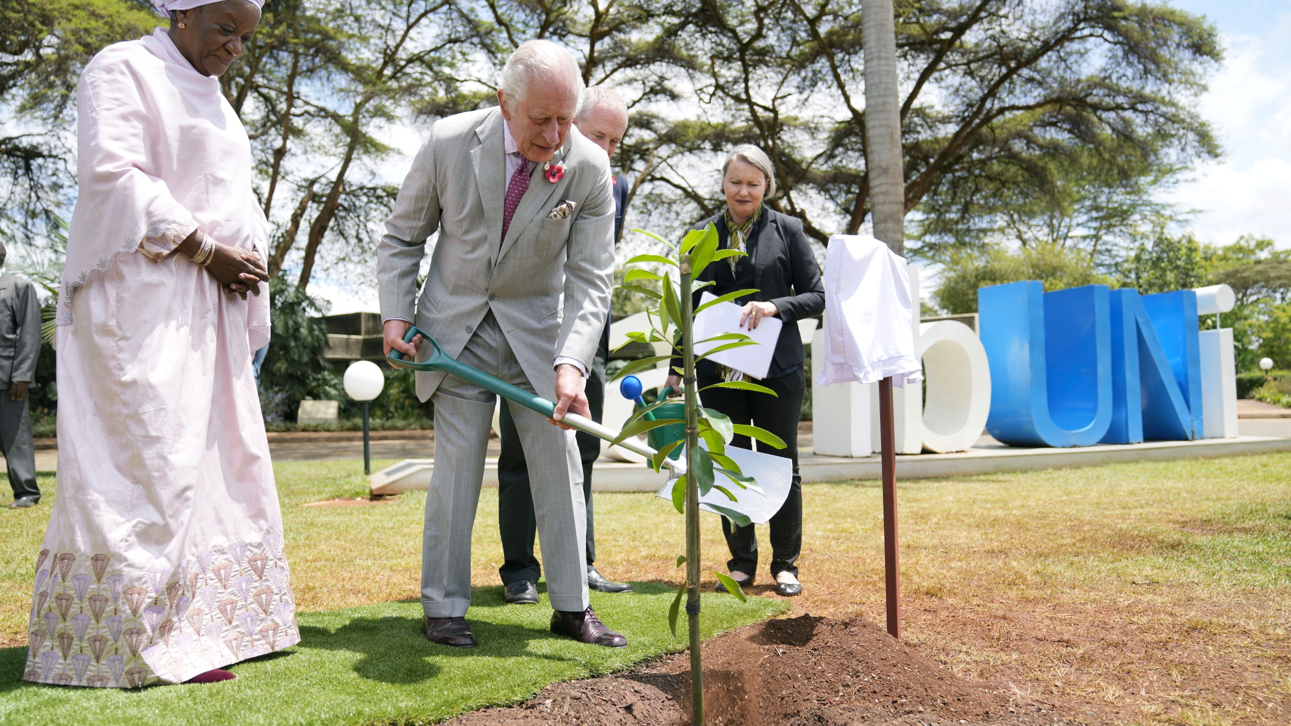 Britain's King Charles III, centre. plants a tree, with Under-Secretary-General of the United Nations, Zainab Hawa Bangura, at left during a visit to the United Nations Office, in Nairobi, Kenya Wednesday, Nov. 1, 2023. (AP Photo/Brian Inganga, Pool)