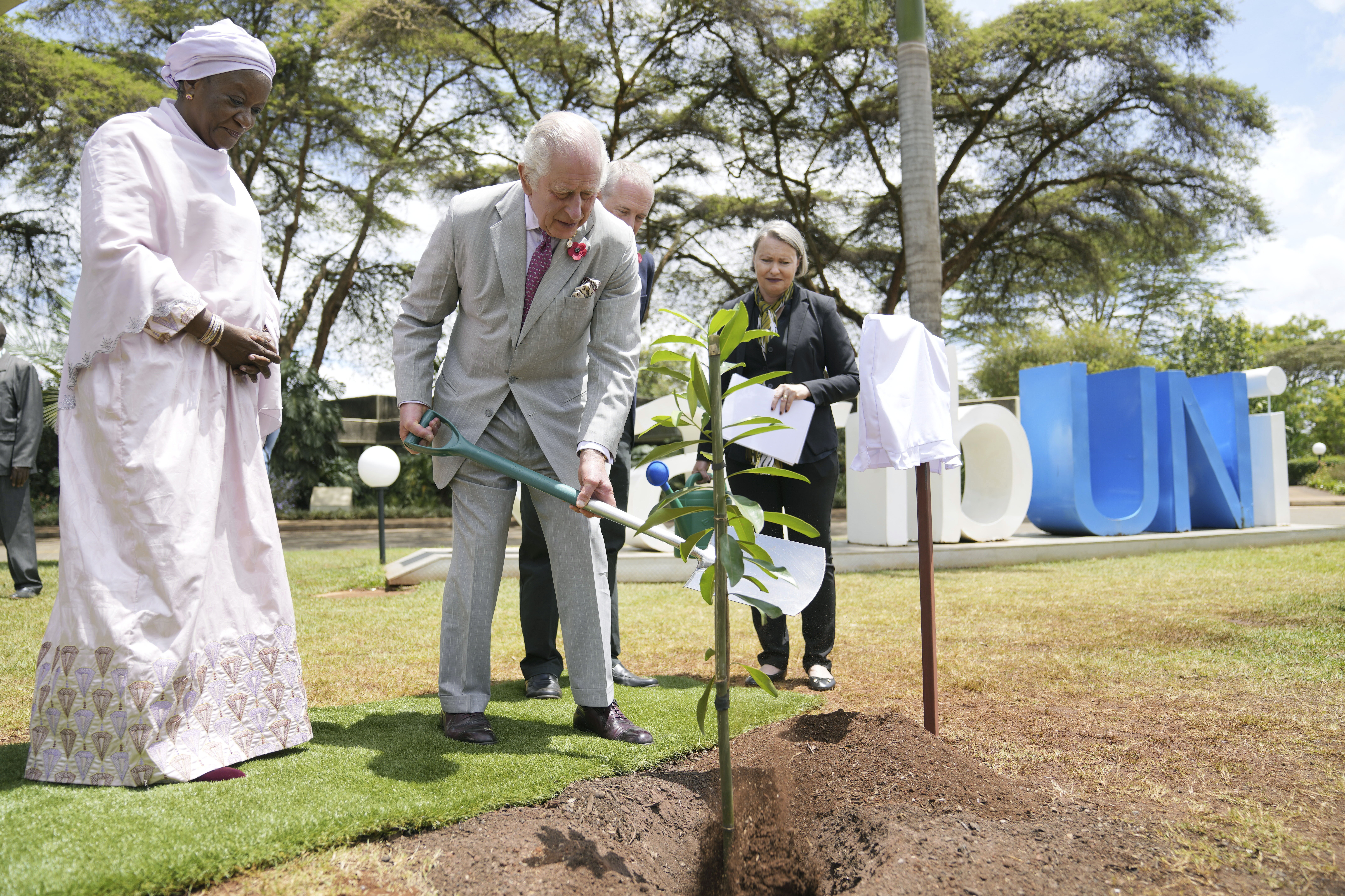 Britain's King Charles III, centre. plants a tree, with Under-Secretary-General of the United Nations, Zainab Hawa Bangura, at left during a visit to the United Nations Office, in Nairobi, Kenya Wednesday, Nov. 1, 2023. (AP Photo/Brian Inganga, Pool)