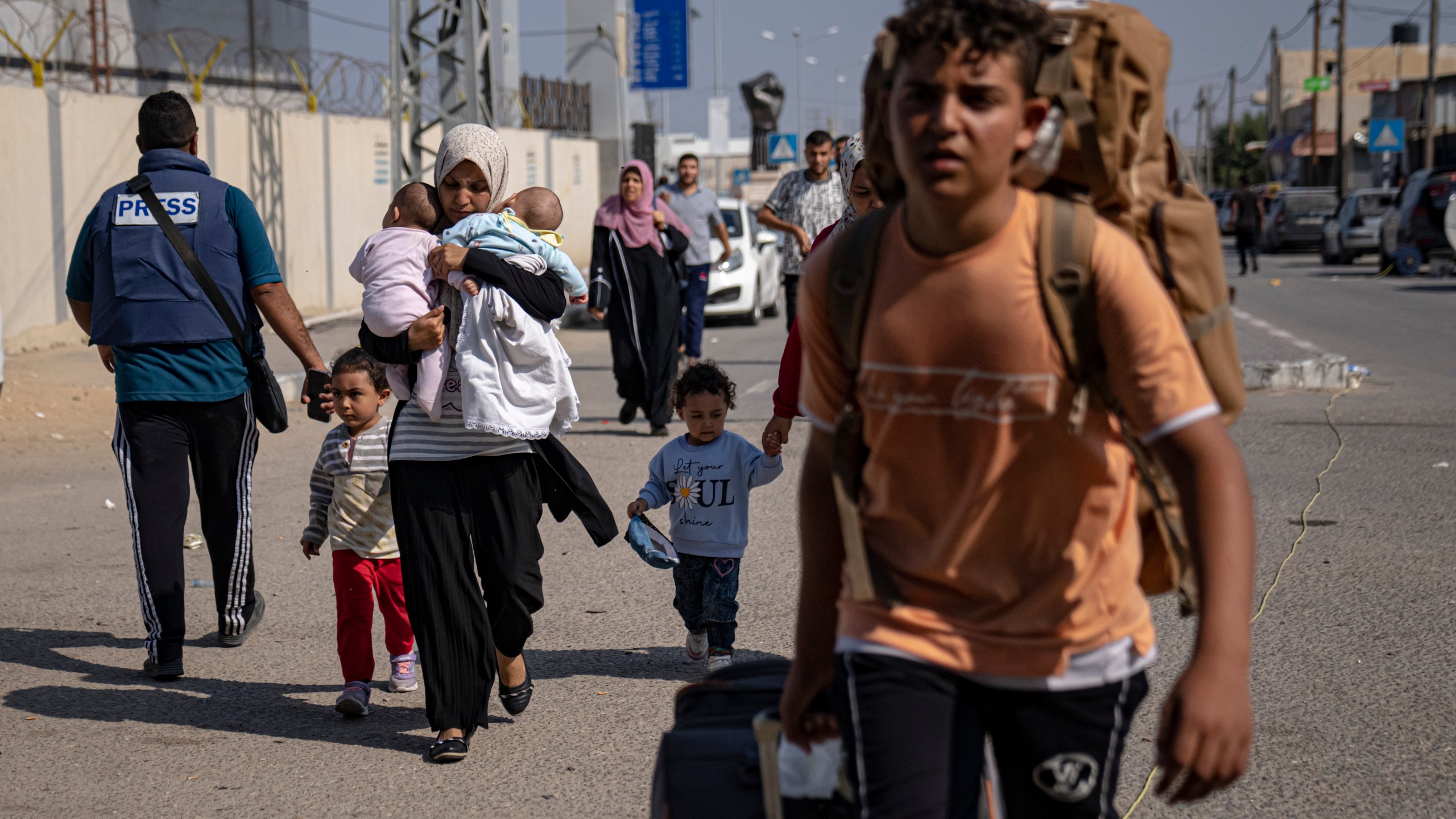 Palestinians arrive at Rafah, the border crossing between the Gaza Strip and Egypt, on Wednesday, Nov. 1, 2023. (AP Photo/Fatima Shbair)