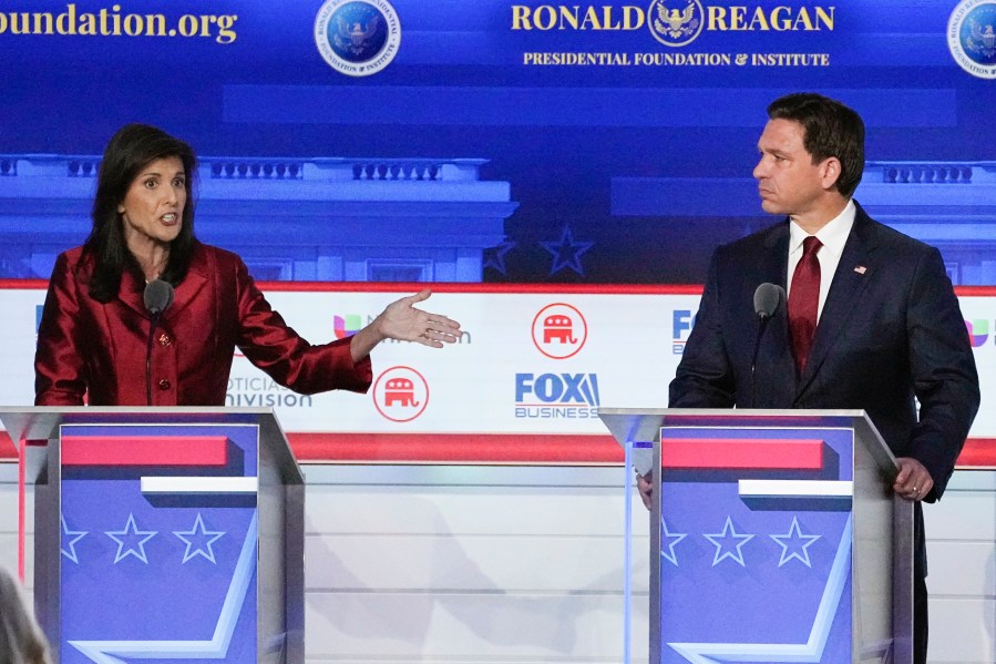 FILE - Republican presidential candidate and former U.N. Ambassador Nikki Haley, left, with Florida Gov. Ron DeSantis, speaks during a Republican presidential primary debate hosted by FOX Business Network and Univision, Sept. 27, 2023, at the Ronald Reagan Presidential Library in Simi Valley, Calif. Haley has been rising with donors and voters thanks in part to strong debate performances and the campaign's increased focus on foreign policy. That's come partly at the expense of Florida Gov. Ron DeSantis. But donors and voters seeking an alternative to former President Donald Trump haven't fully coalesced around Haley. (AP Photo/Mark J. Terrill, File)