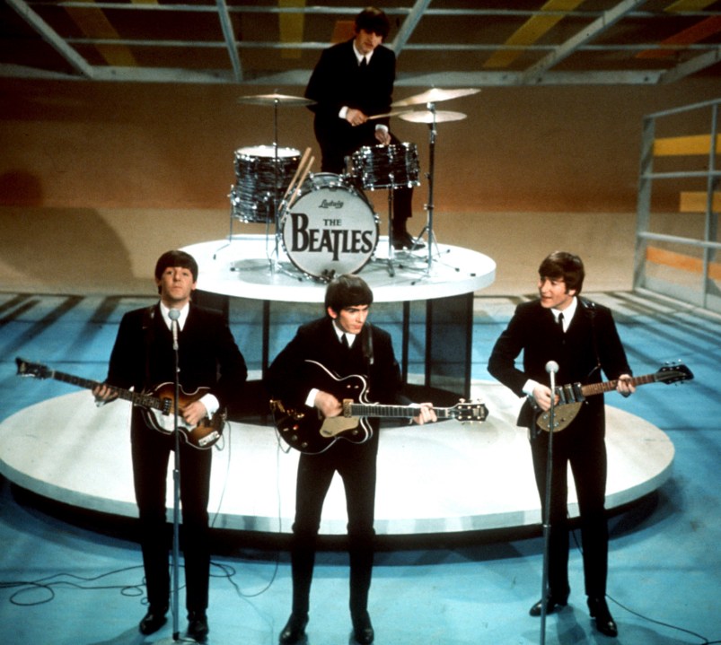 FILE -The Beatles, foreground from left, Paul McCartney, George Harrison, John Lennon and Ringo Starr on drums perform on the CBS "Ed Sullivan Show" in New York on Feb. 9, 1964. Sixty years after the onset of Beatlemania and with two of the quartet now dead, artificial intelligence has enabled the release of a “new” Beatles song.“Now And Then,” will be available Thursday, Nov. 2. (AP Photo/File)