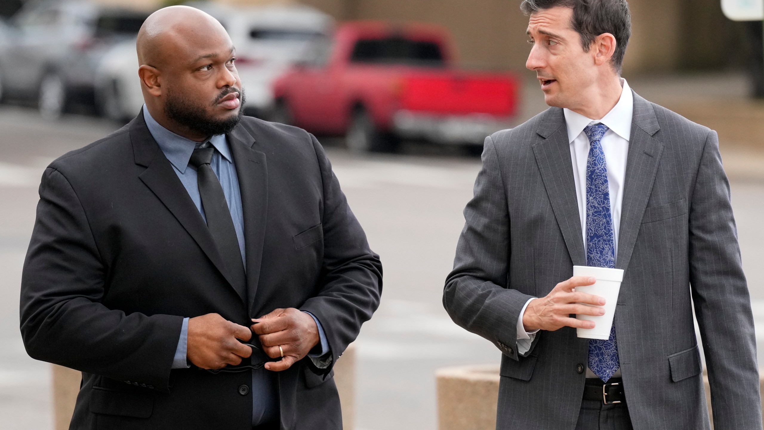 Former Memphis police officer Desmond Mills, left, arrives at the federal courthouse with his attorney Blake Ballin, right, to testify against his former colleagues during the trial in the Tyre Nichols case Wednesday, Sept. 25, 2024, in Memphis, Tenn. (AP Photo/George Walker IV)