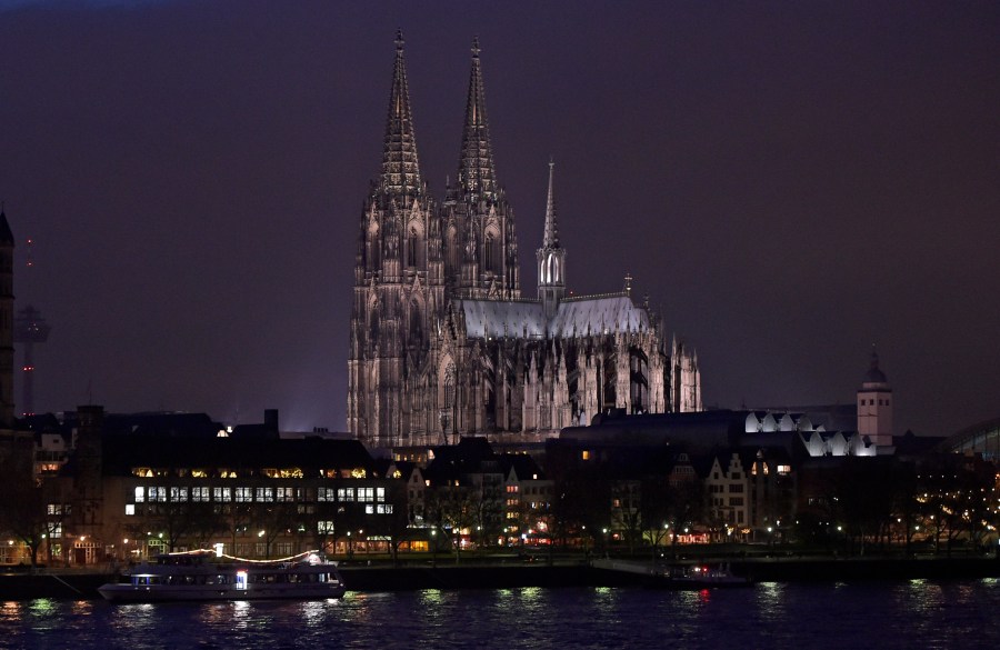 FILE - The Cologne cathedral is illuminated in Cologne, Germany, Monday, Jan. 5, 2015. (AP Photo/Martin Meissner, File)