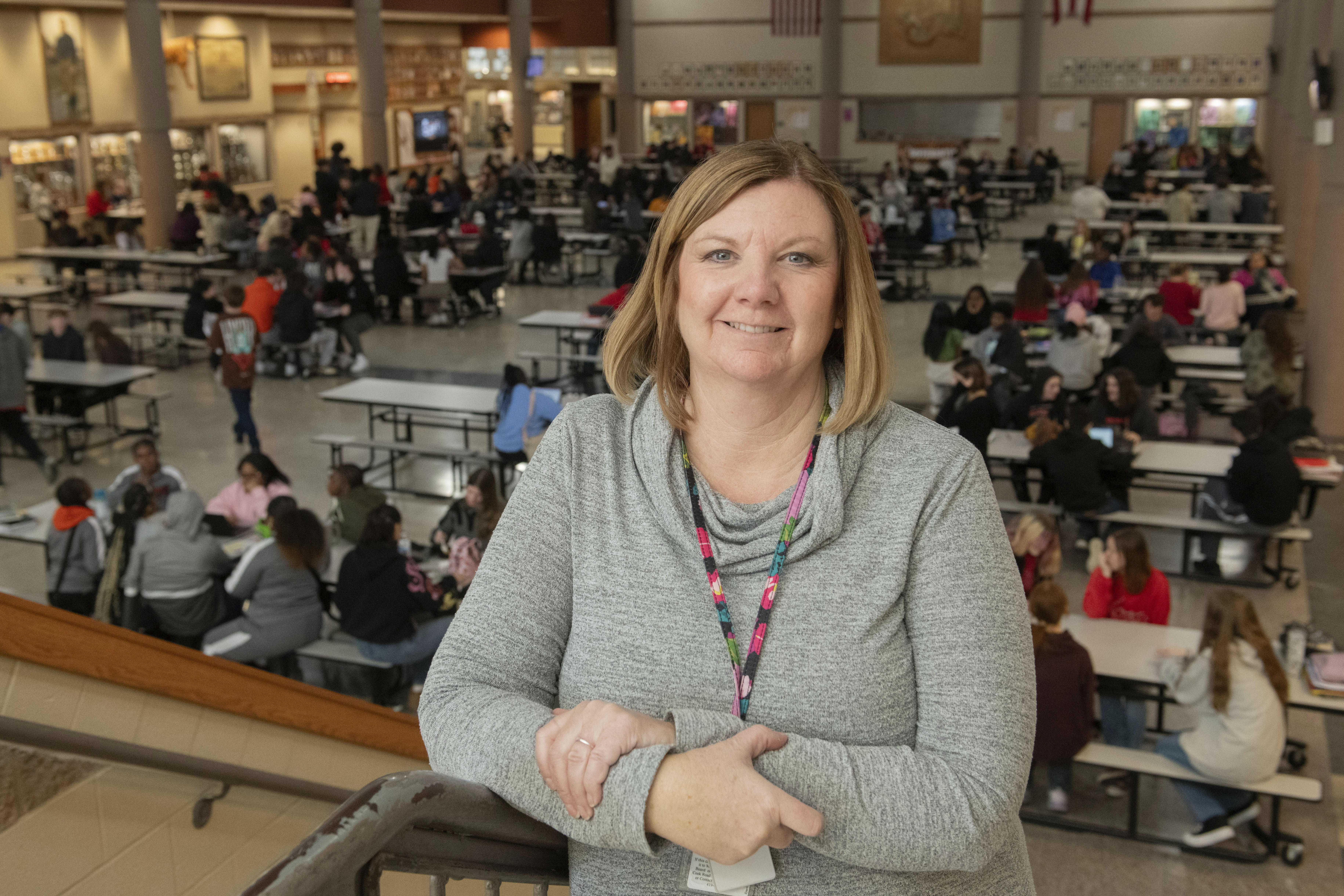 Mansfield Senior High School attendance coordinator Kari Cawrse stands with the school cafeteria in the background in Mansfield, Ohio, Friday, Dec. 6, 2024. (AP Photo/Phil Long)