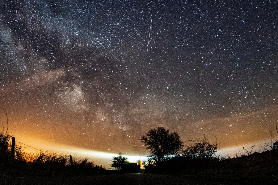 FILE - The Lyrid meteor shower is seen over Burg on the Baltic Sea island of Fehmarn off Germany, Friday, April 20, 2018. (Daniel Reinhardt/dpa via AP, File)