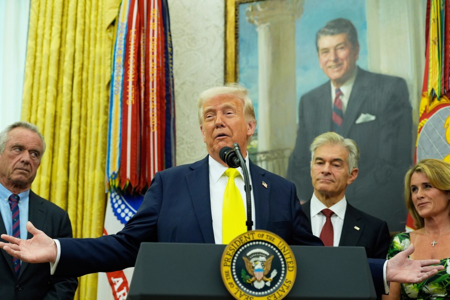 President Donald Trump speaks as Health and Human Services Secretary Robert F. Kennedy Jr., from left, Dr. Mehmet Oz and Oz's wife Lisa Oz listen during a swearing in ceremony for Mehmet oz to be Administrator of the Centers for Medicare and Medicaid Services, in the Oval Office of the White House, Friday, April 18, 2025, in Washington. (AP Photo/Alex Brandon)