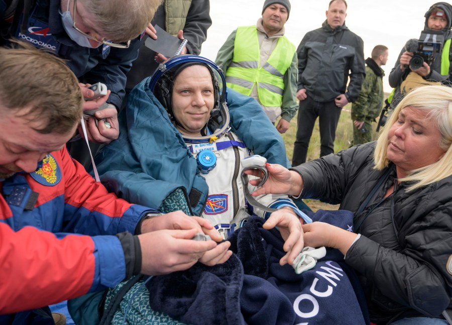 Roscosmos cosmonaut Ivan Vagner sits outside the Soyuz MS-26 spacecraft after landing with NASA astronaut Don Pettit and fellow cosmonaut Alexey Ovchinin in a remote area near the town of Zhezkazgan, Kazakhstan on Sunday, April 20, 2025. (Bill Ingalls/NASA via AP)